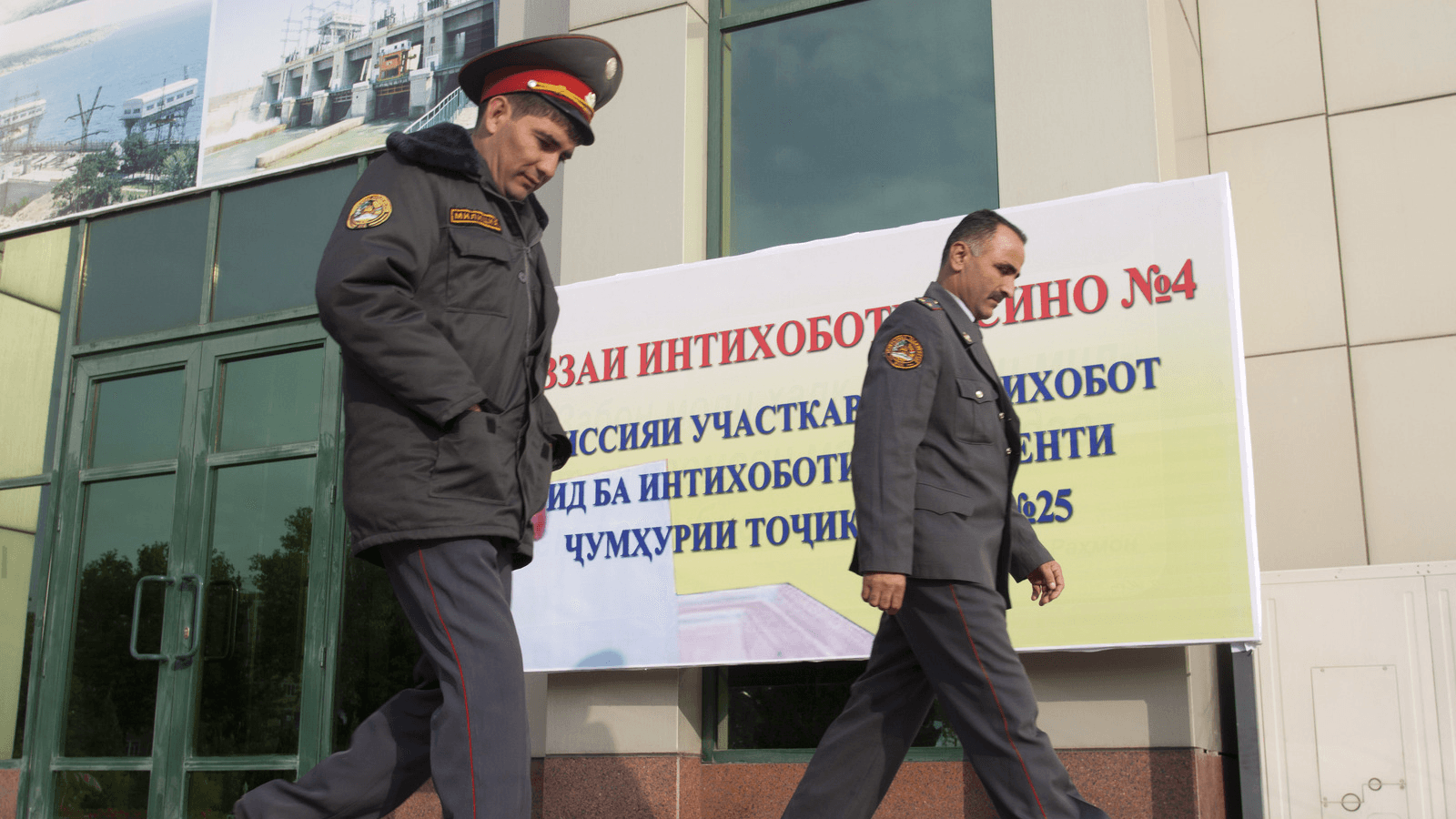 Police officers walk outside a polling station in Dushanbe, Tajikistan, Nov. 1, 2013. Tajikistan has recently announced a registry of allegedly gay citizens.
