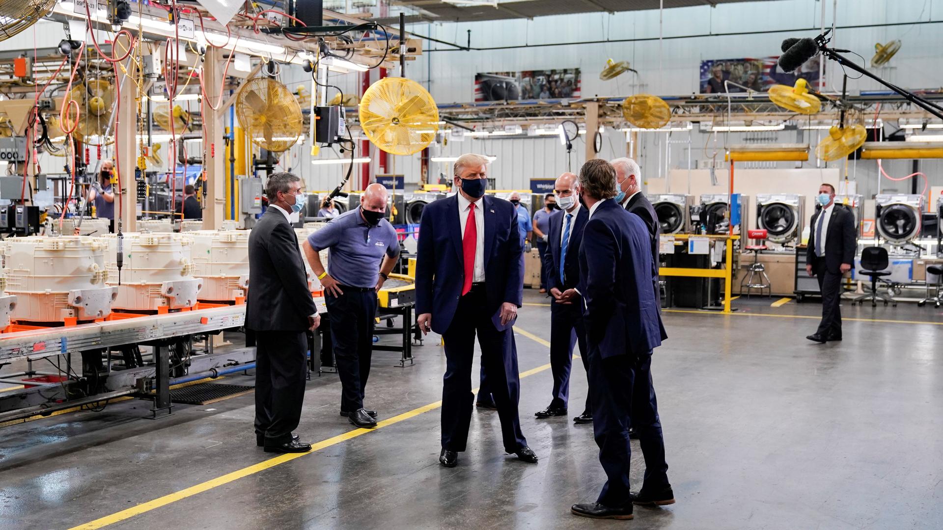 US President Donald Trump wears a protective face mask due to the coronavirus disease (COVID-19) pandemic as he tours the assembly line at a Whirlpool Corporation washing machine factory in Clyde, Ohio, Aug. 6, 2020.