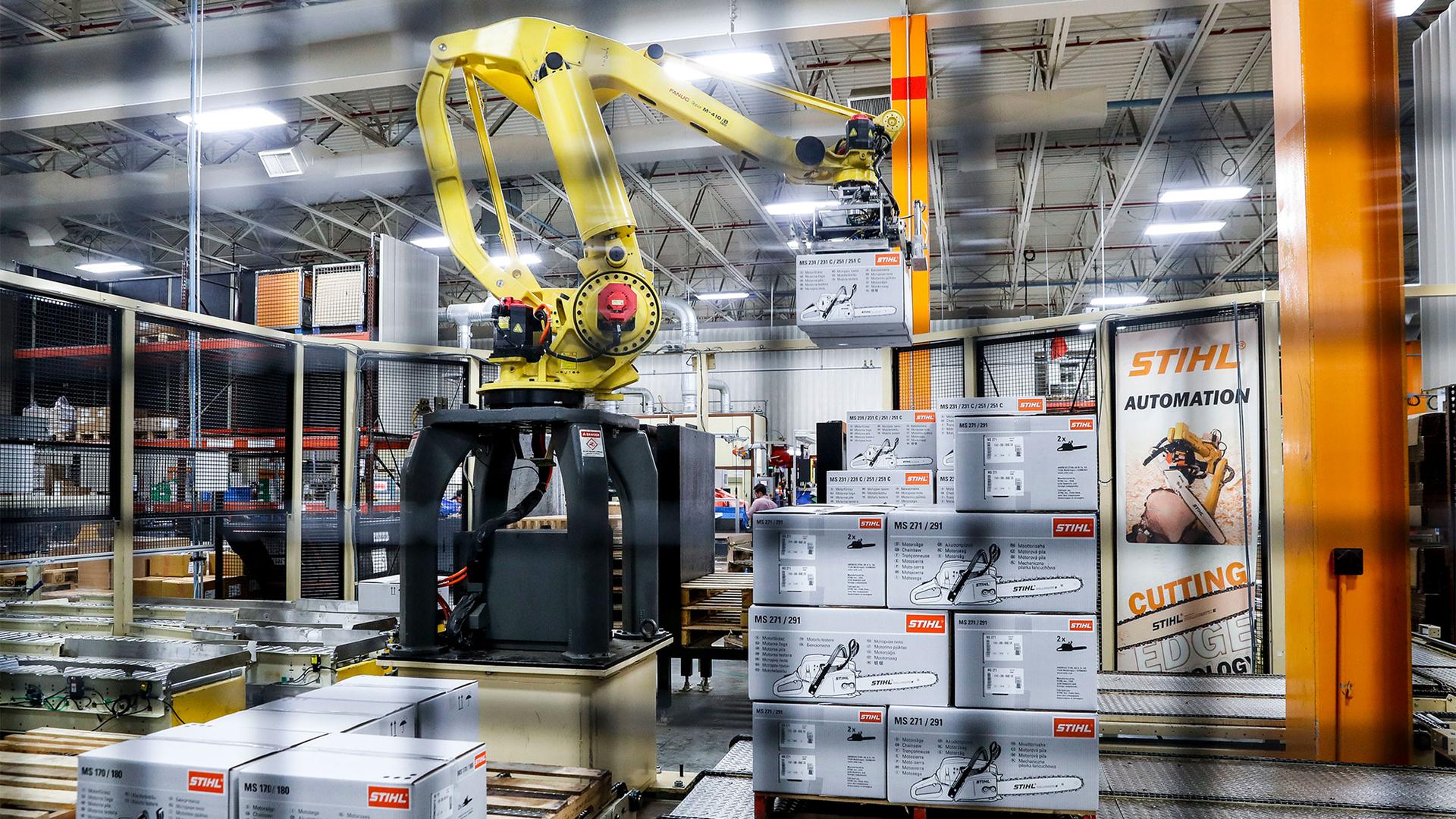 A giant robotic arm loads pallets full of chainsaws prepared for shipping at the Stihl Inc. production plant in Virginia Beach, Va.