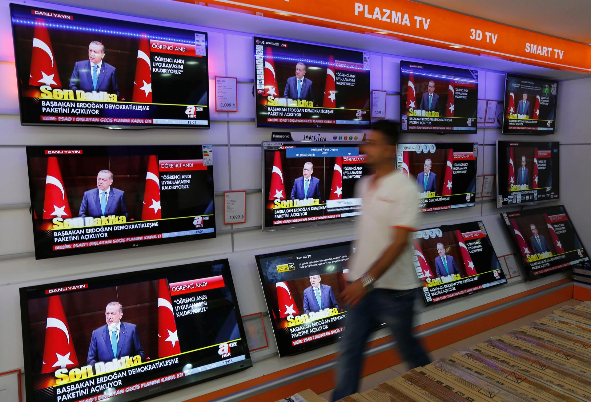 A news conference of Turkish Prime Minister Tayyip Erdogan is screened on televisions at an electronics shop in Istanbul September 30, 2013. Erdogan announced a so-called "democratization package" that would allow for education in languages other than Tur