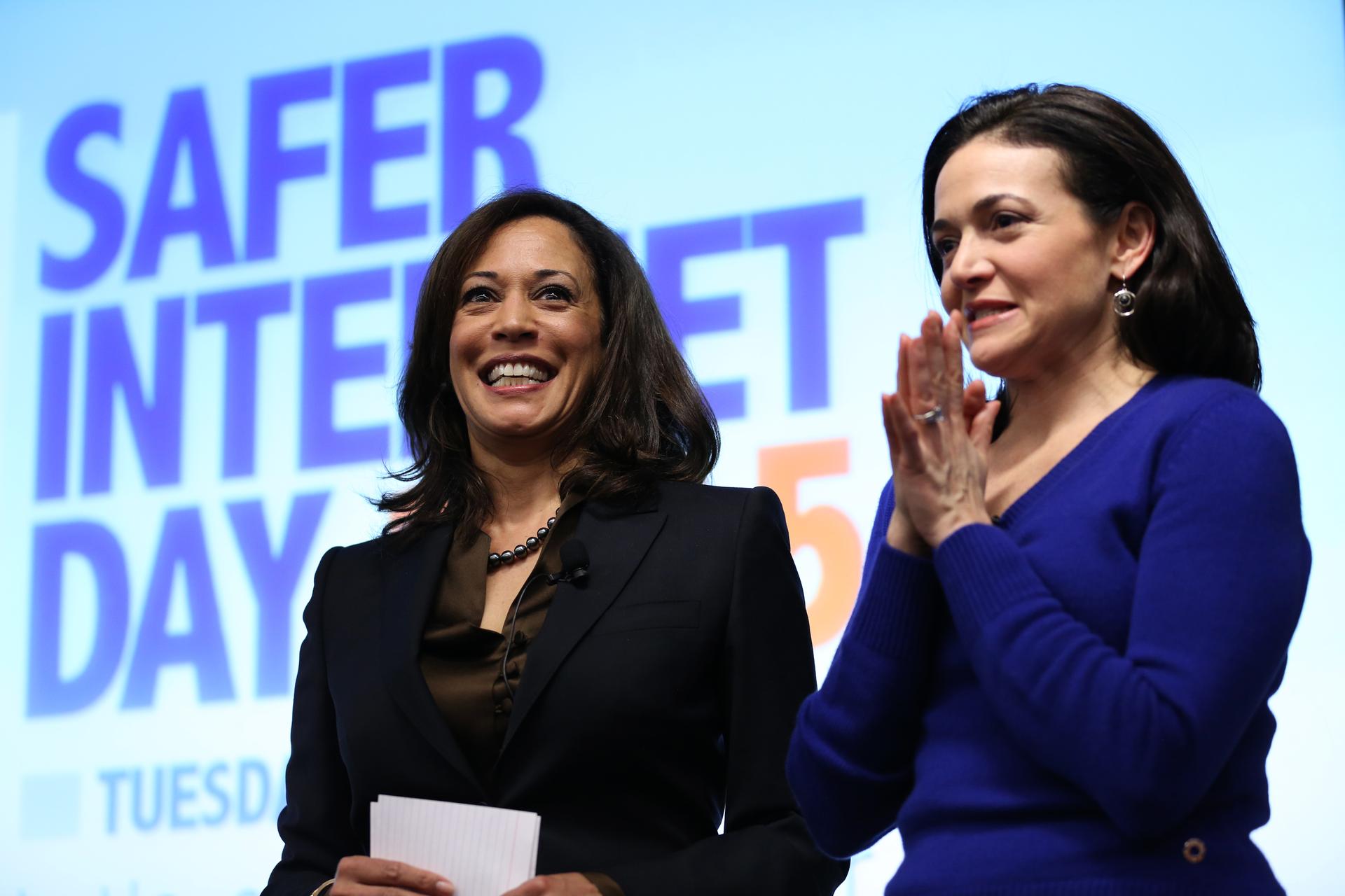 California Attorney General Kamala Harris, at left, shares the stage with Facebook COO Sheryl Sandberg following Harris' address at the Facebook headquarters in Menlo Park, California on February 10, 2015.