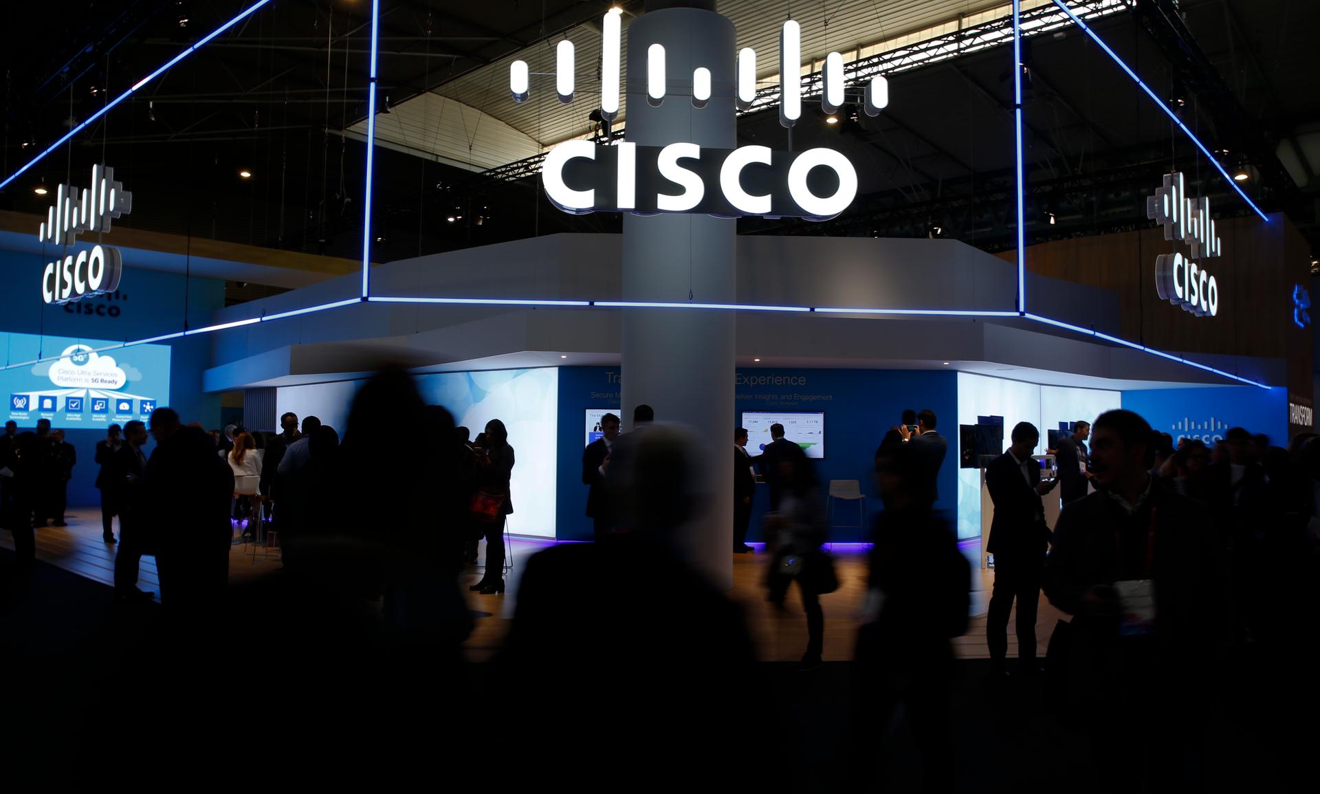 Visitors walk past Cisco's booth during Mobile World Congress in Barcelona, Spain, February 27, 2017.