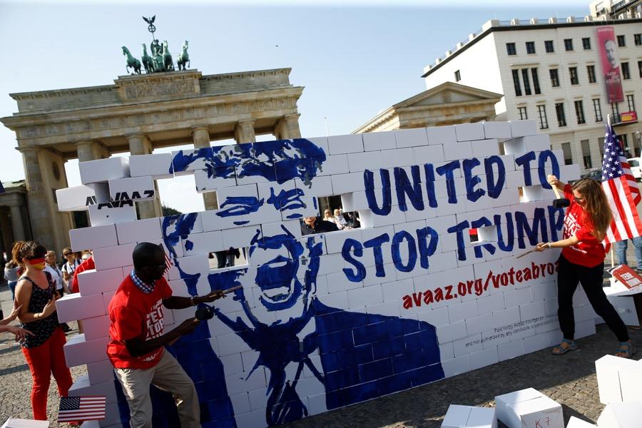 Activists pose on a "United To Stop Trump" cardboard wall in front of the Brandenburg Gate in Berlin, Germany to urge Americans abroad to vote, on Sept. 23.
