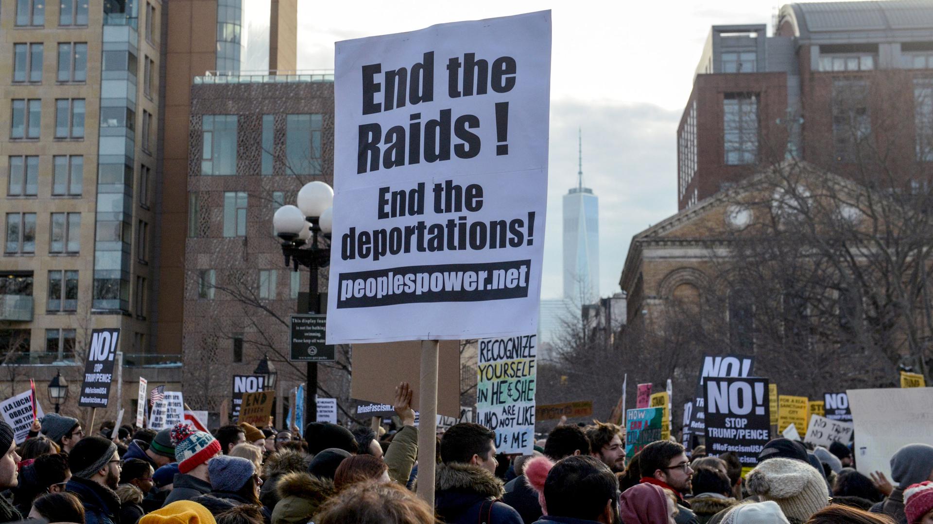 A sign at a February protest in New York calls for an end to immigration raids and deportations.