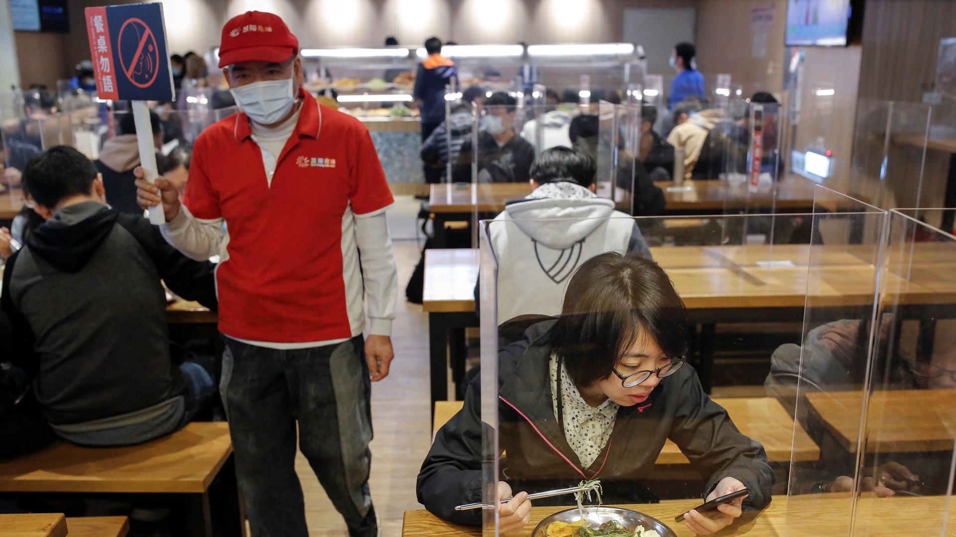 Students eat lunch between dividers to protect them from the coronavirus disease (COVID-19) in the canteen of the National Taiwan University of Science and Technology (NTUST) in Taipei, Taiwan, April 6, 2020.