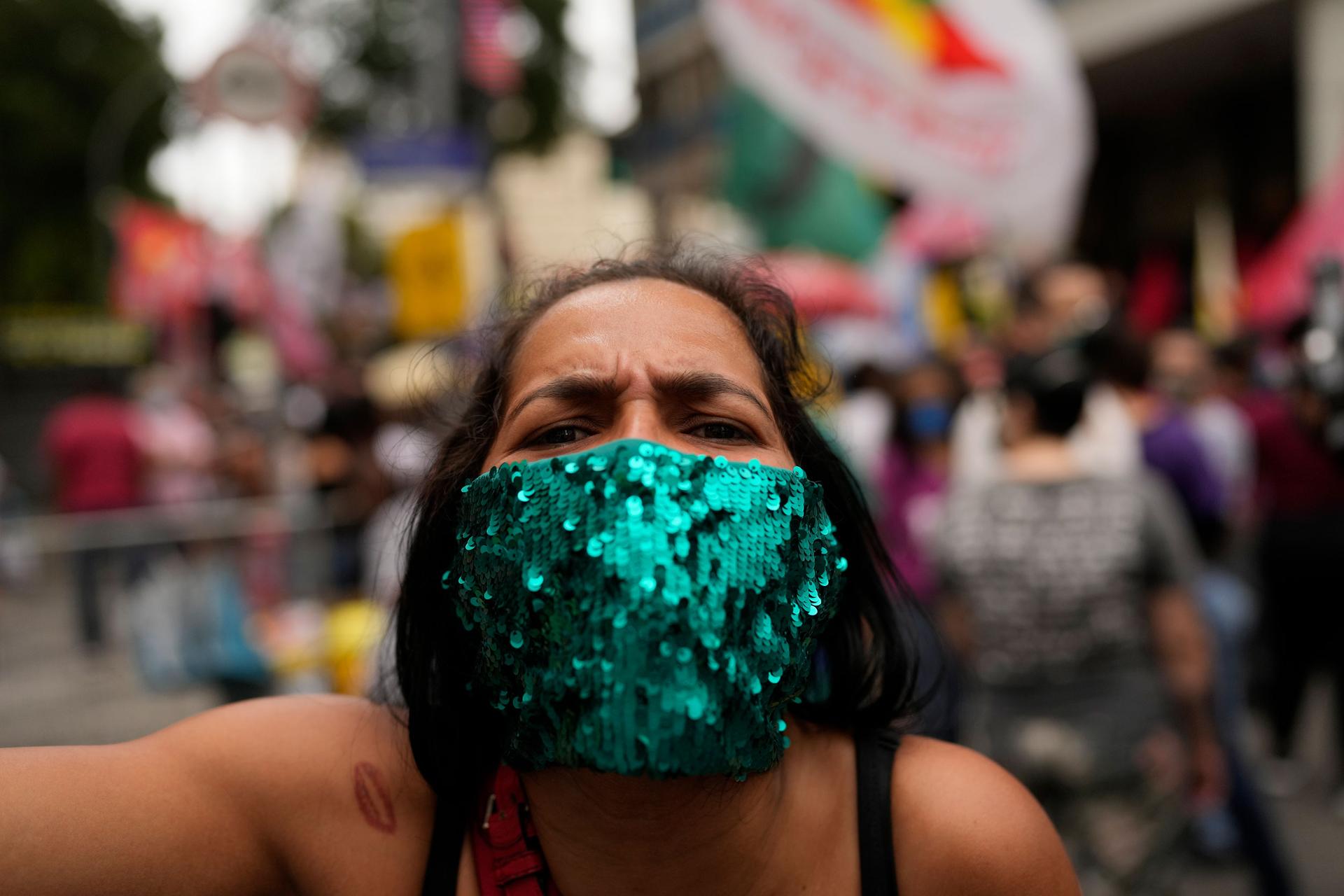 A woman attends a protest against Brazilian President Jair Bolsonaro's handling of the COVID-19 pandemic, the economy and corruption, on Independence Day in Rio de Janeiro, Brazil, Tuesday, Sept. 7, 2021. 