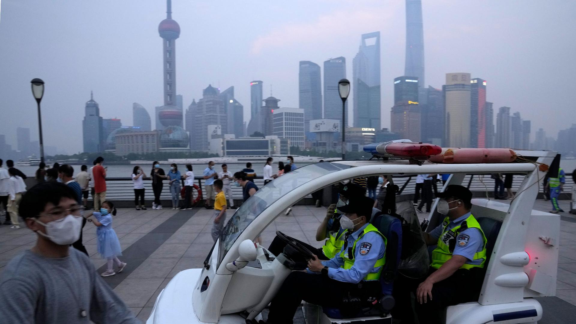 Chinese policemen patrol the bund area in Shanghai, June 1, 2022.
