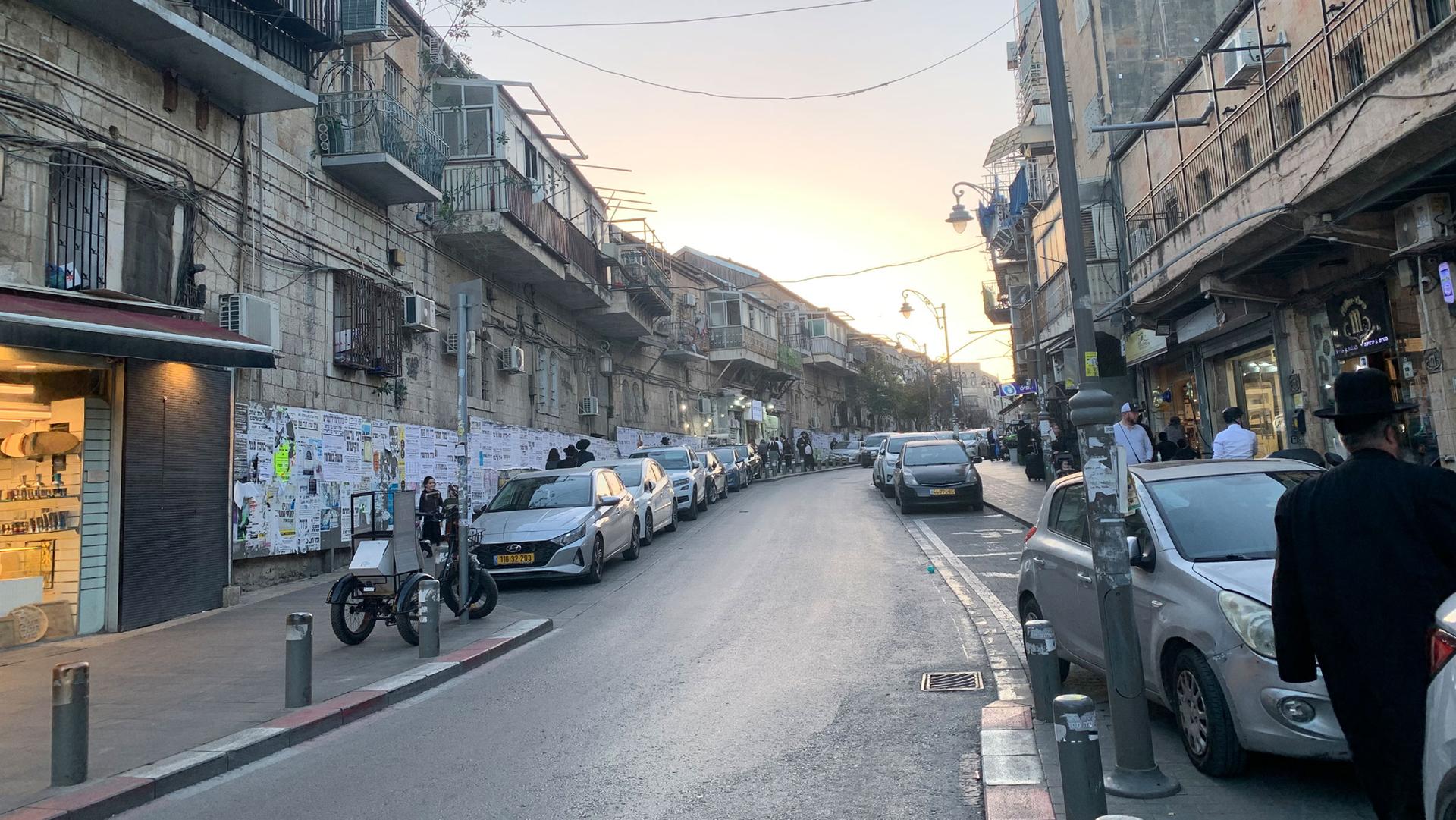 A densely packed street of businesses and apartment buildings in Mea She'arim.