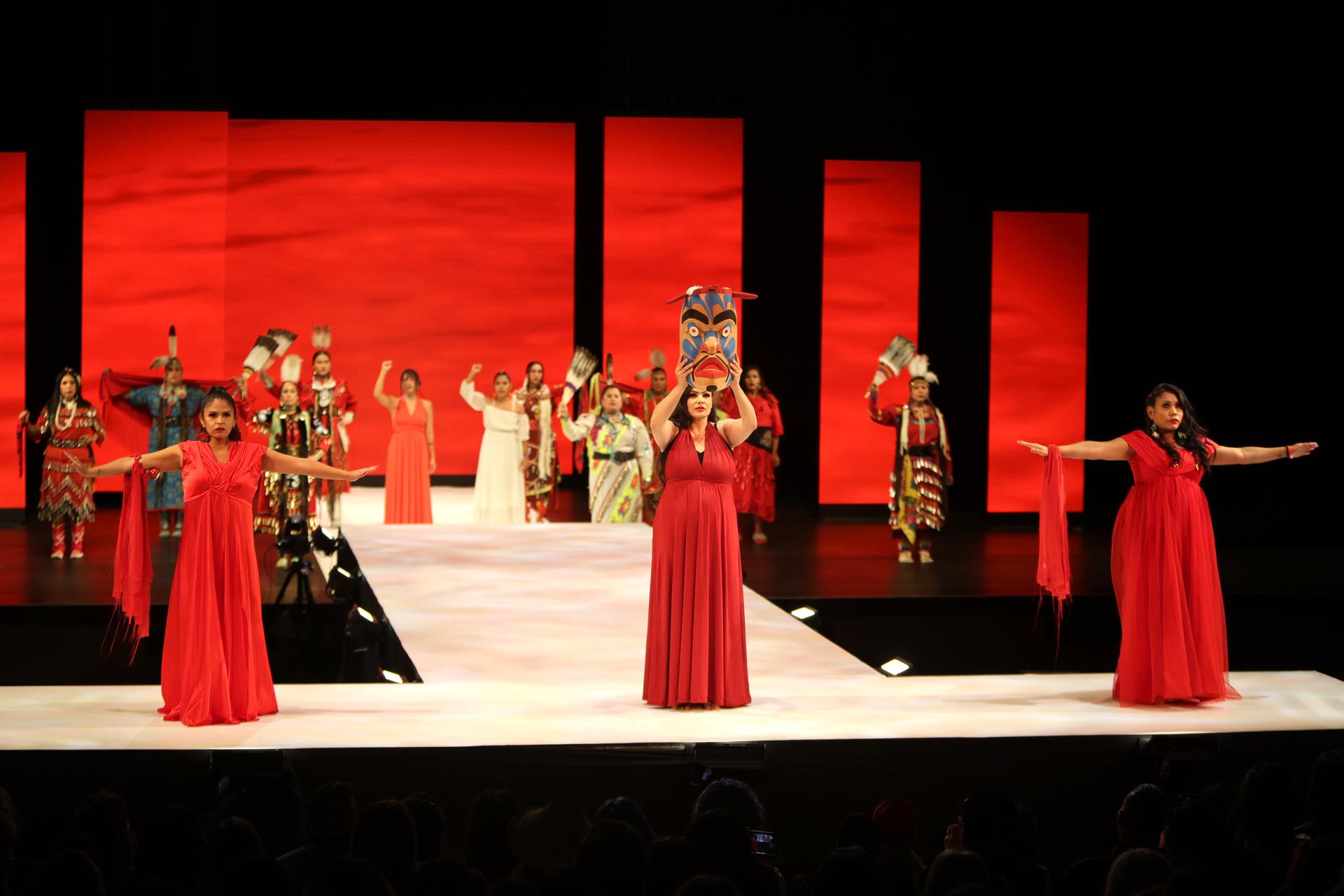 The Red Dress night opened with a powerful depiction of Indigenous female strength and resilience in a dance choreographed by Madelaine McCallum (center).