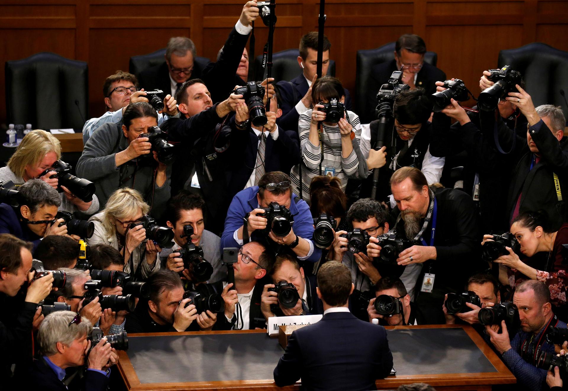 The picture show's the back of Facebook CEO Mark Zuckerberg who is surrounded by photographers.