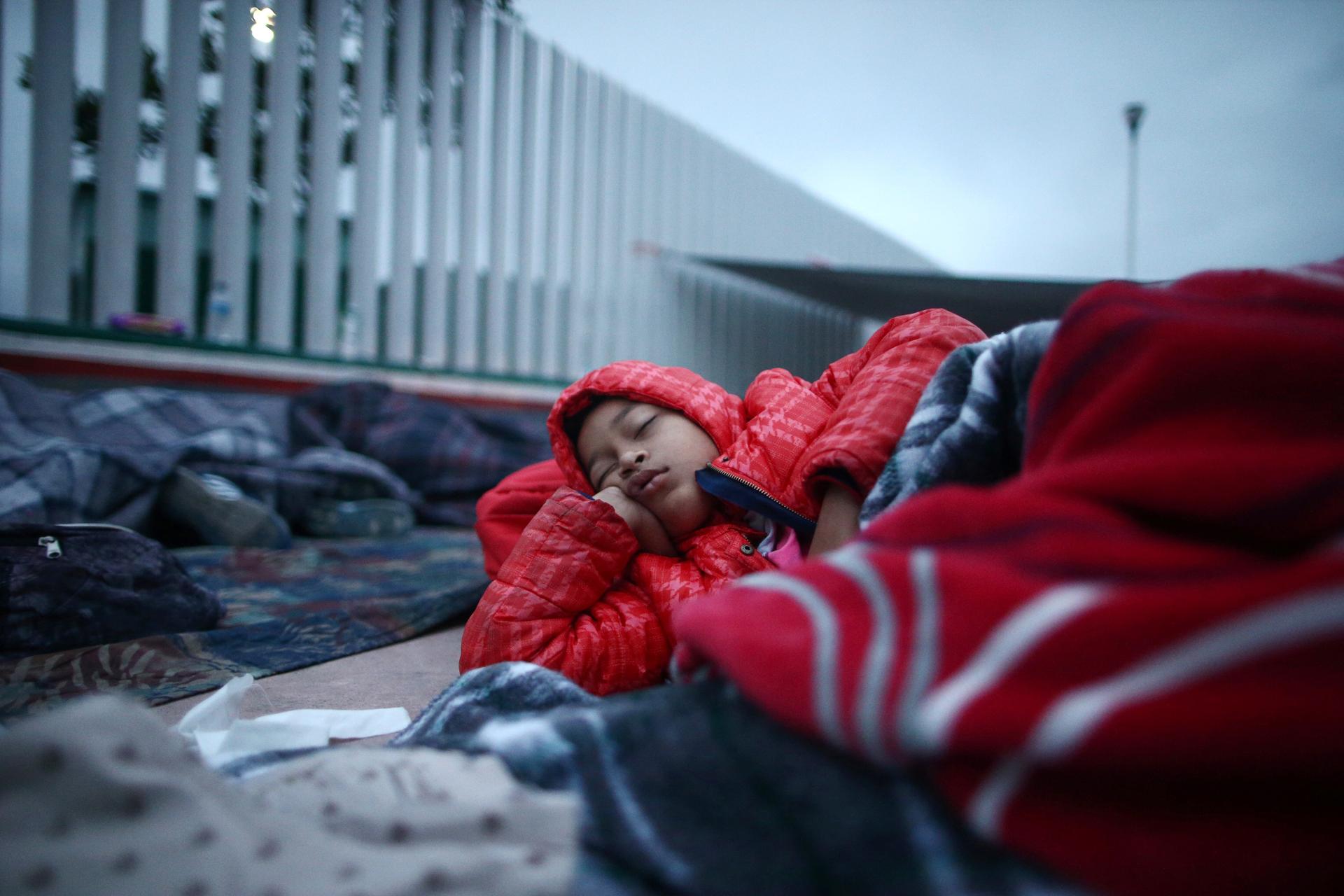 A child traveling with a caravan of migrants from Central America sleeps near the San Ysidro checkpoint in Tijuana, Mexico, April 30, 2018.