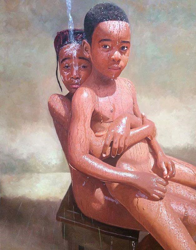 Boy sitting on girl's lap.