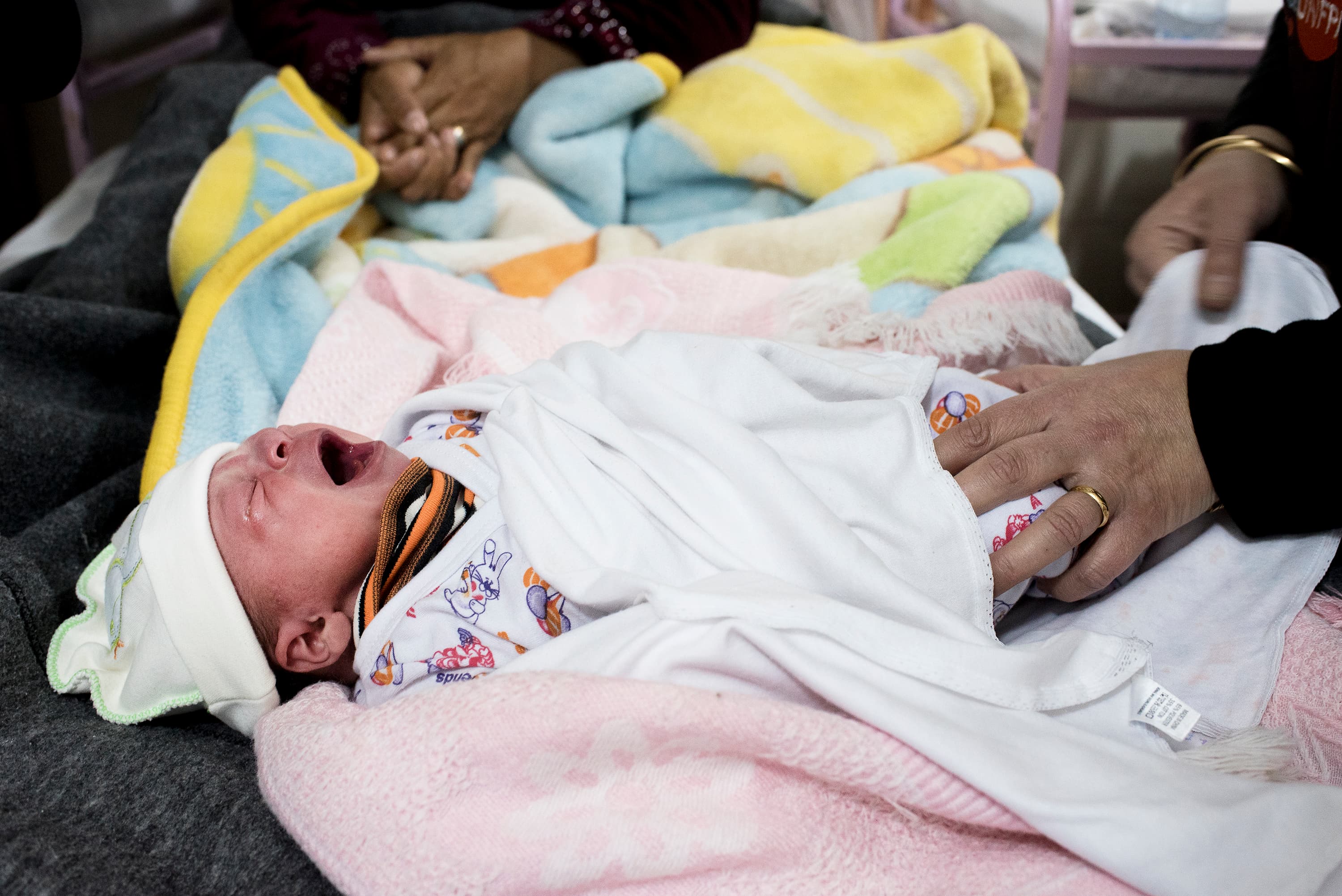 A midwife checks on baby Shafagh at the maternity clinic in Zaatari refugee camp. Shafagh was born 7 hours before the photo was taken.