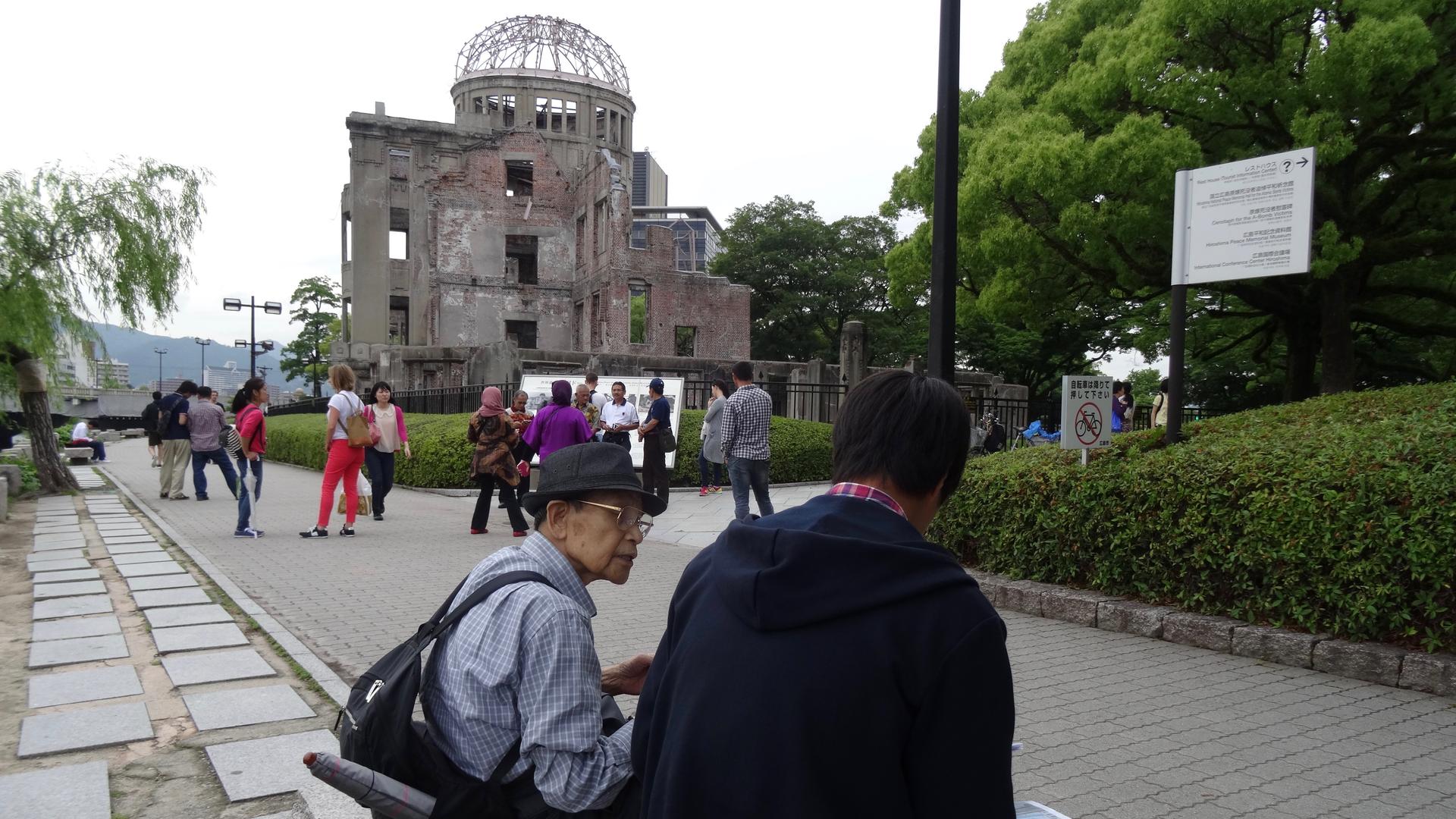 Hiroshima survivor Noriho Azuma (wearing a hat) in front of the A-bomb dome in June of 2015.
