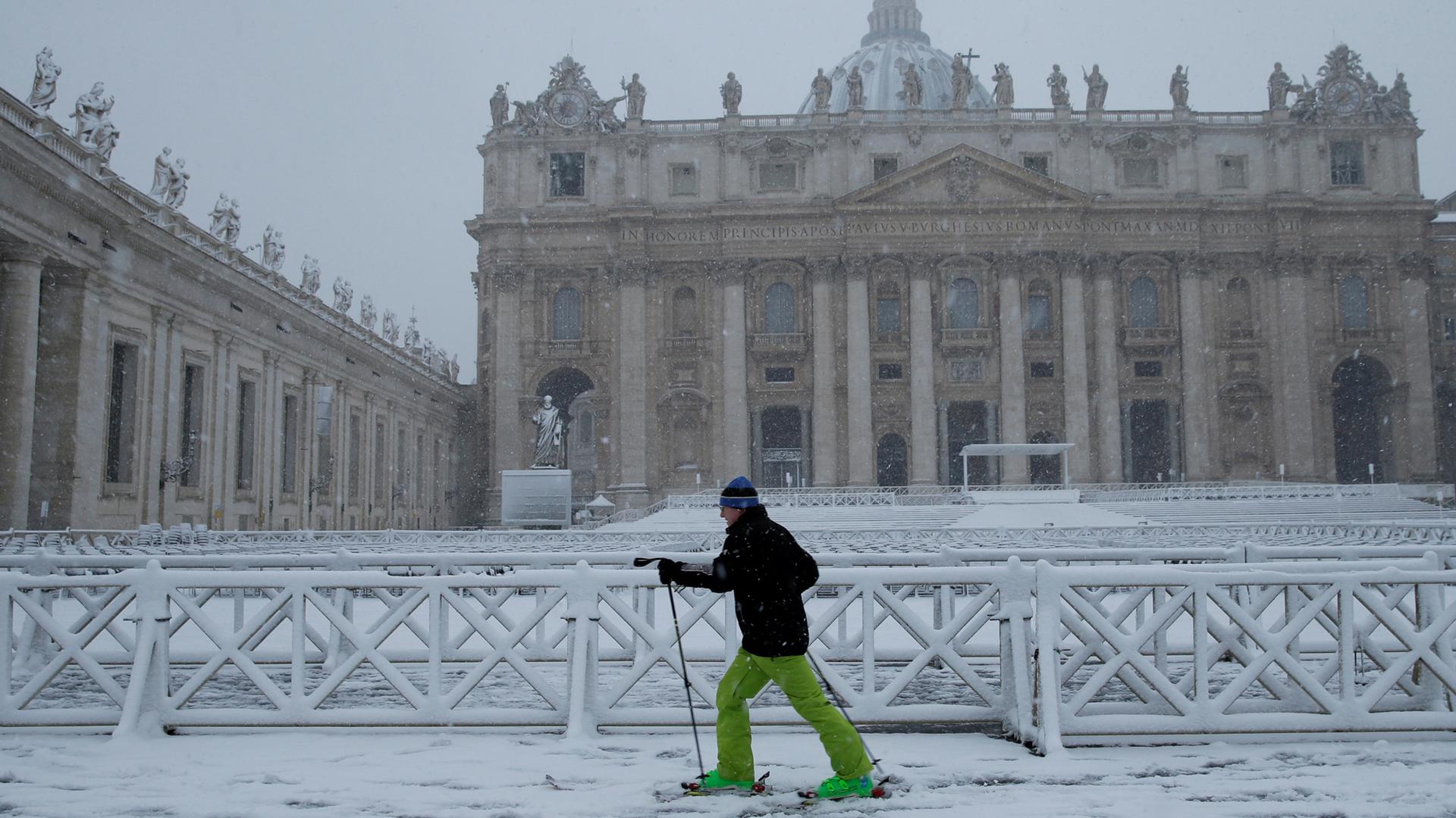 A man skis during a heavy snowfall in Saint Peter's Square at the Vatican Feb. 26, 2018.