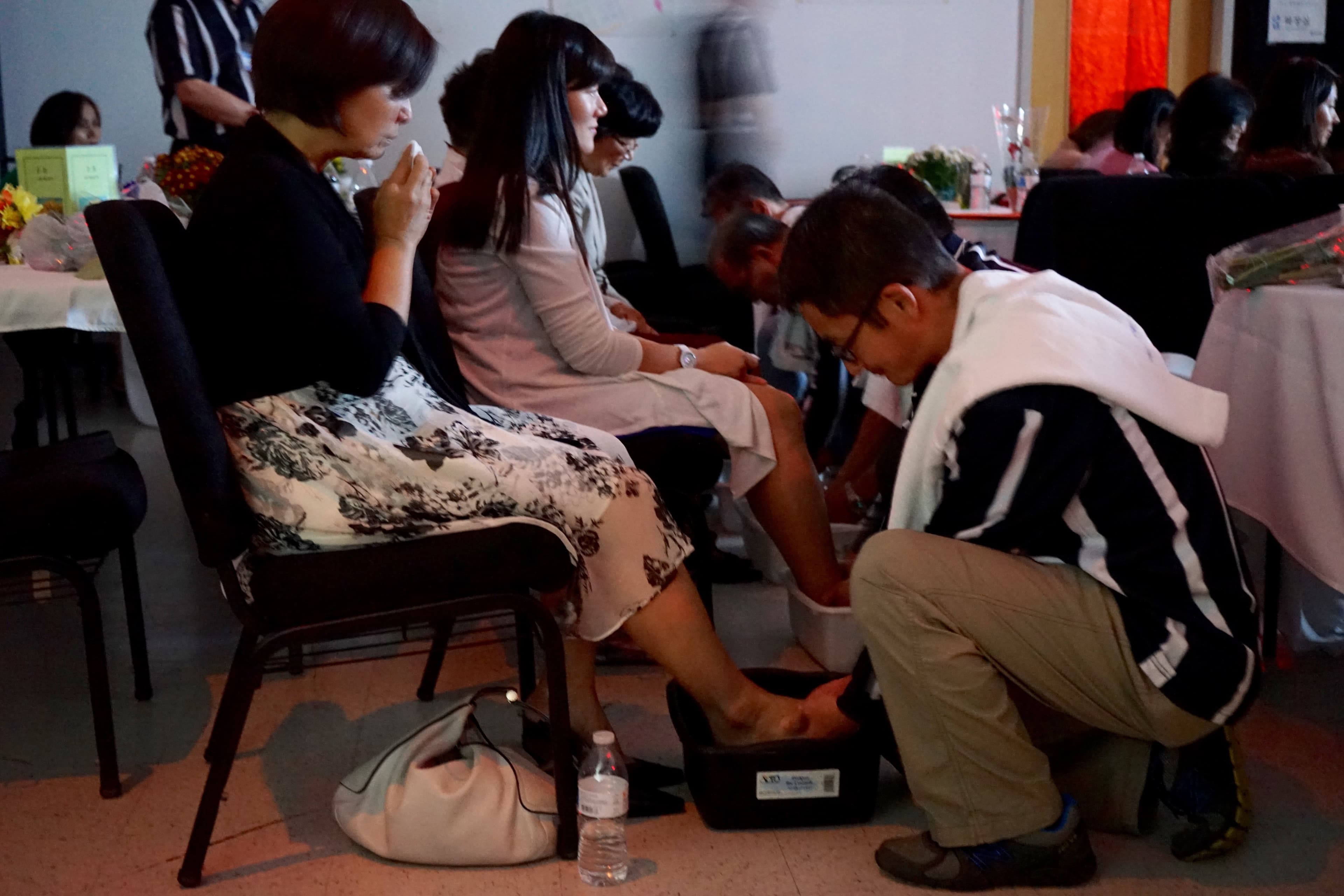 At the Father School graduation, men wash their wives' feet, just as Jesus washed the feet of his disciples in the Bible.