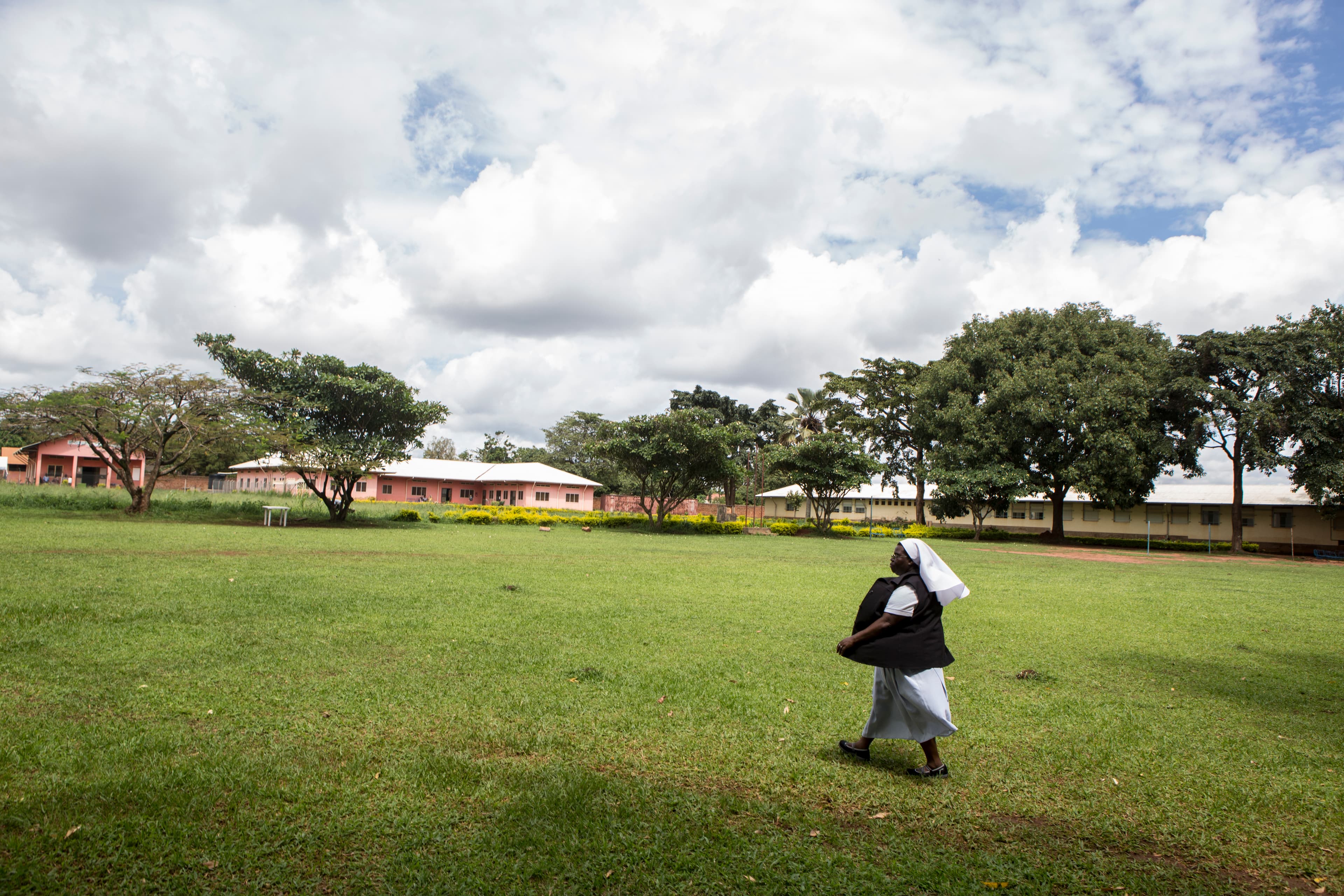 Sister Rosemary striding across the yard at St. Monica Girls' Vocational School.