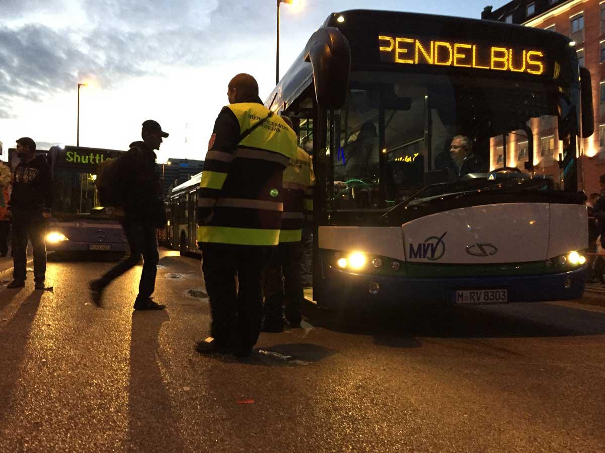 Migrants board a bus at Munich’s central train station. It will take them to a temporary camp, where they will begin the months-long asylum application process.