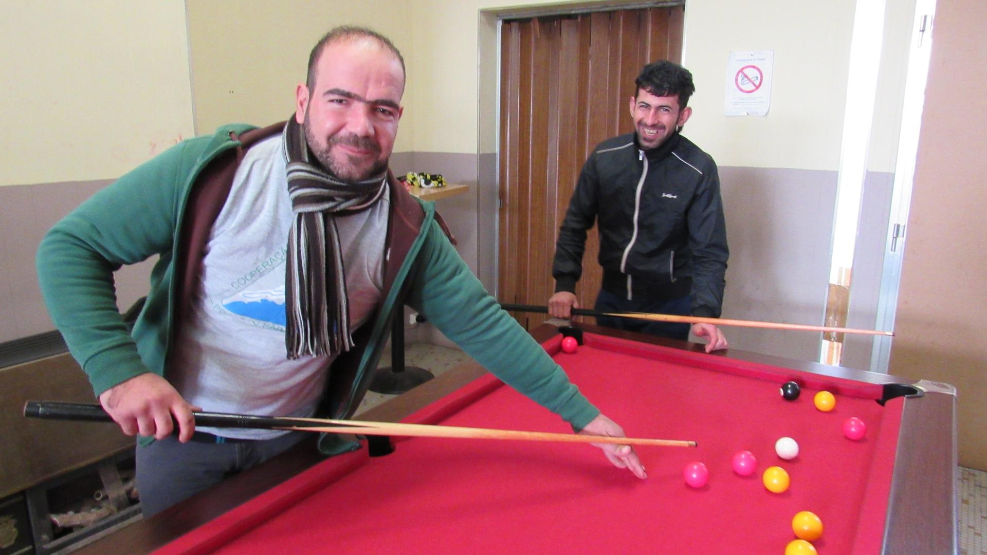 Two Kurdish migrants from a nearby refugee camp enjoy the warm, the tea and the fun of Café Elleboode.