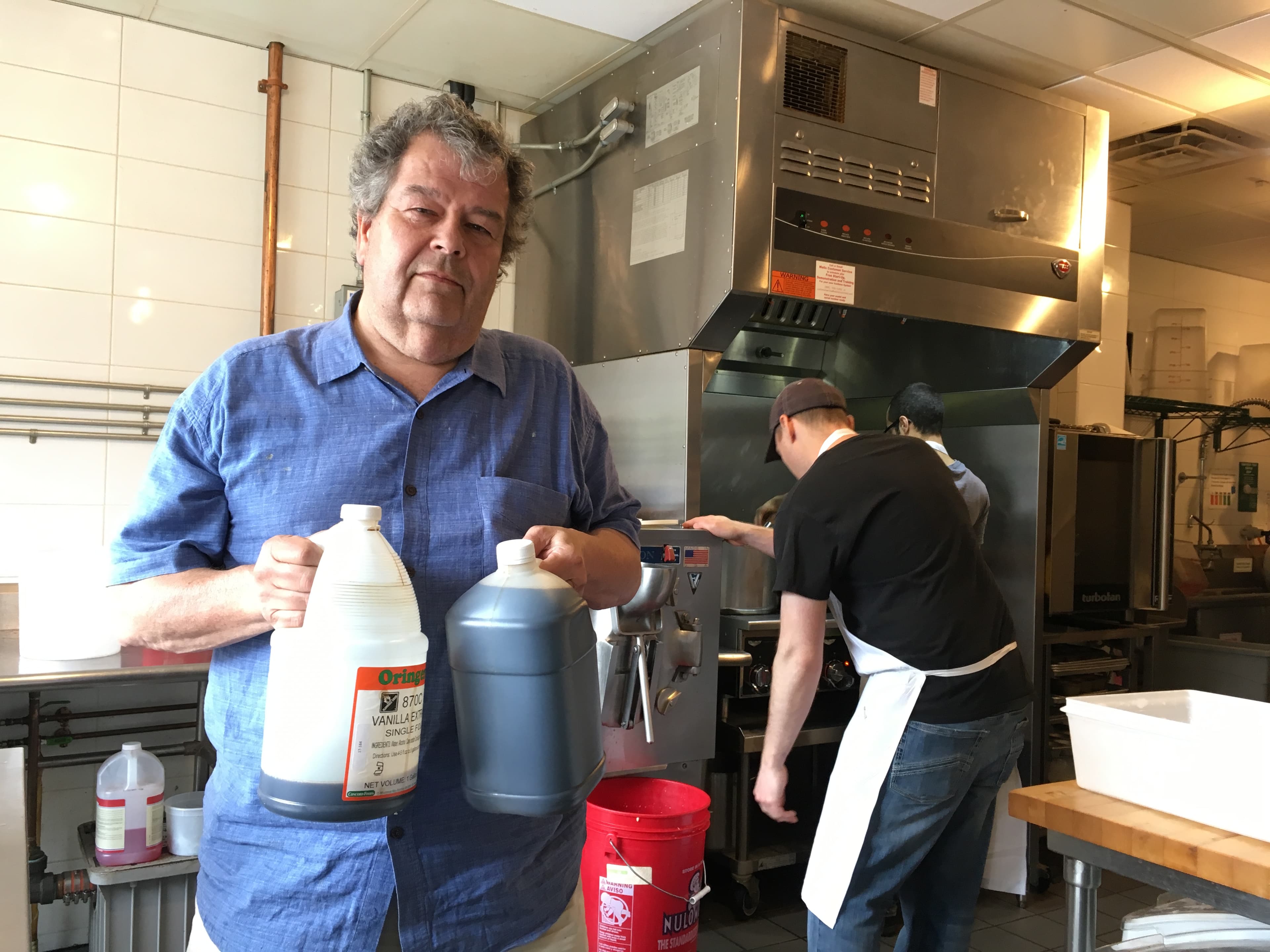 Gus Rancatore, owner of Toscanini’s ice cream, holds some of the vanilla extracts he has left.