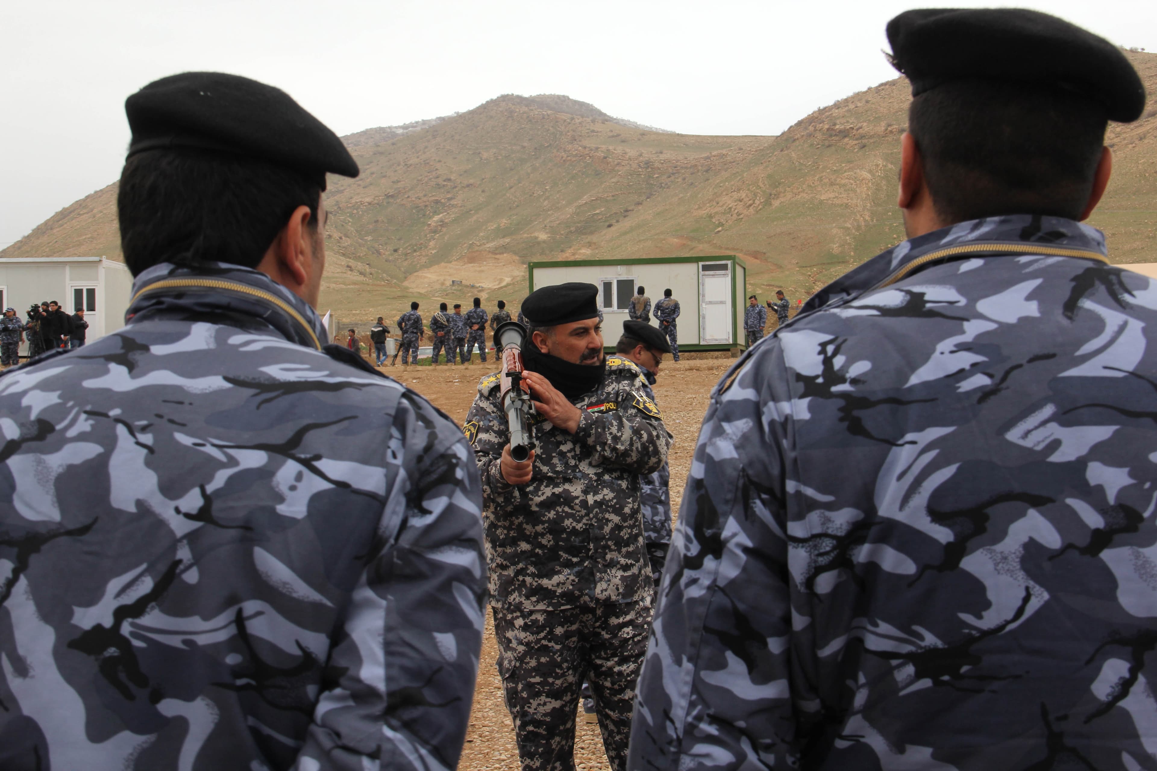An instructor shows off a launch tube for a rocket-propelled grenade at a training camp near Erbil, Iraq.