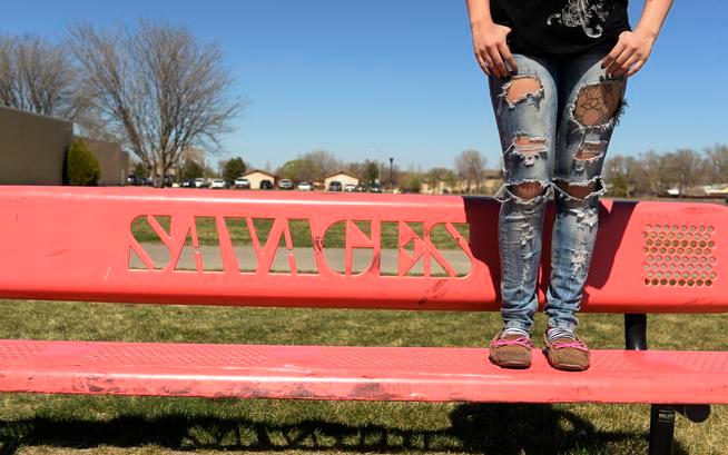 Lamar High School tenth grader, Jalyssa Flores, stands on a bench outside the high school, March 31, 2015. Flores hopes the school school will be able to keep their mascot name, the Lamar Savages, and it won't be changed to the Lamar Snow Geese.