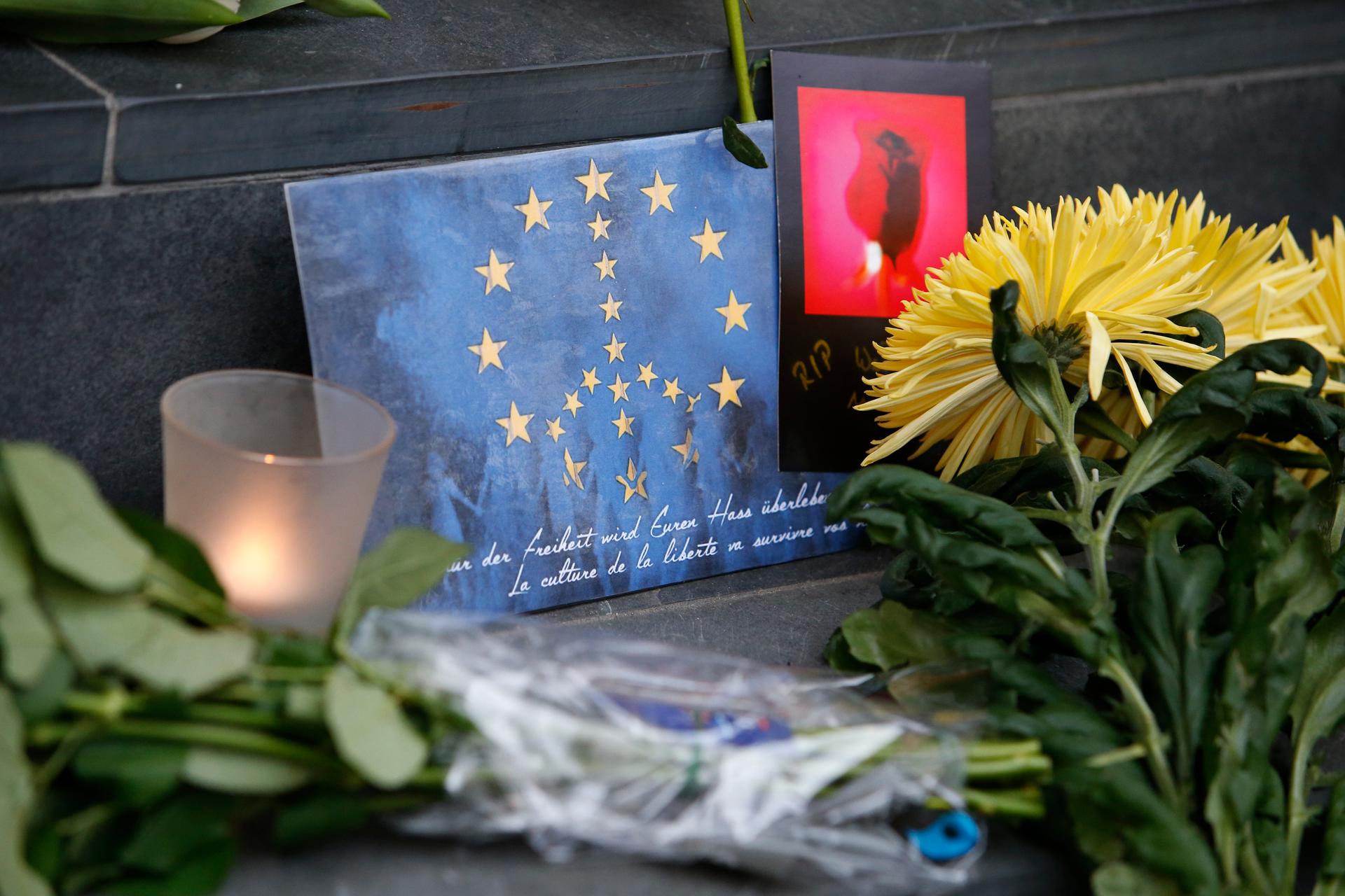 Flowers and a candle for the victims of today's Brussels attacks, are placed on the steps of the Belgian embassy in Berlin, Germany,