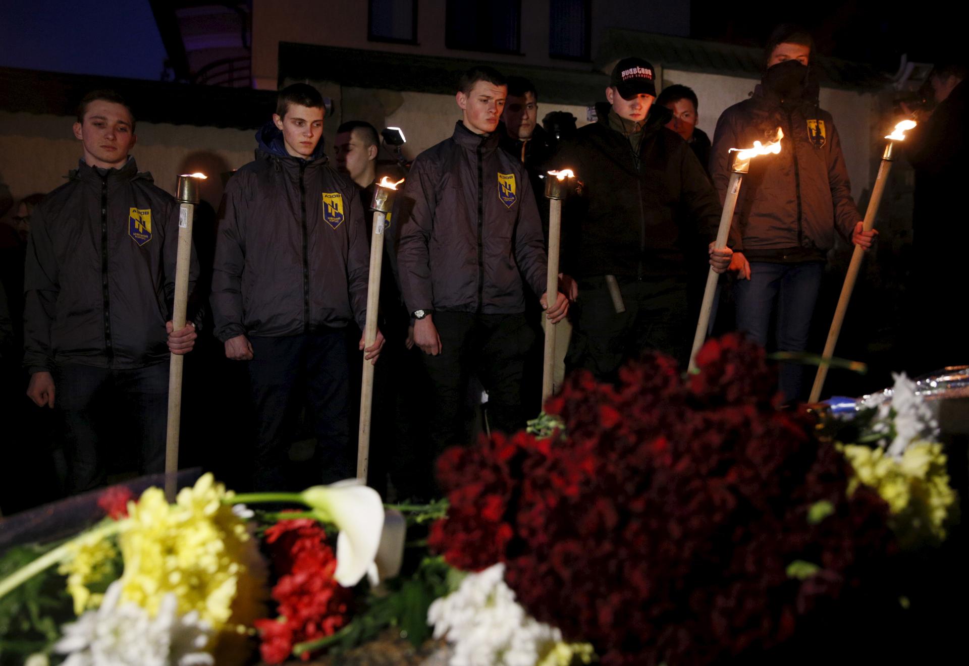 Activists of the Azov civil corp commemorate the victims of today's Brussels attacks near the Belgian embassy in Kiev, Ukraine, March 22, 2016.