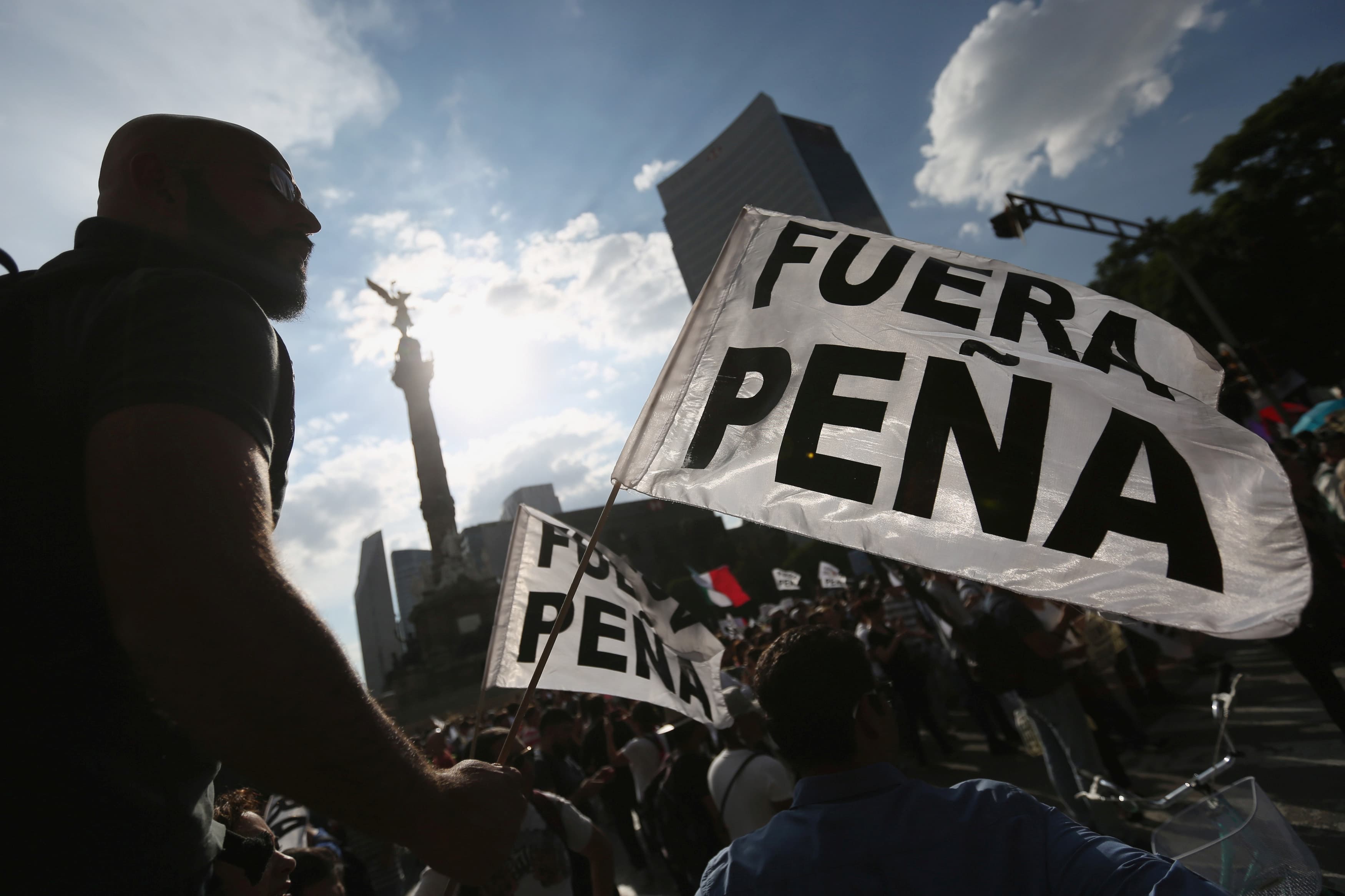 Demonstrators hold flags as they take part during a march demanding the resignation of President Enrique Pena Nieto in downtown Mexico City, Mexico, September 15, 2016. The flag reads, 