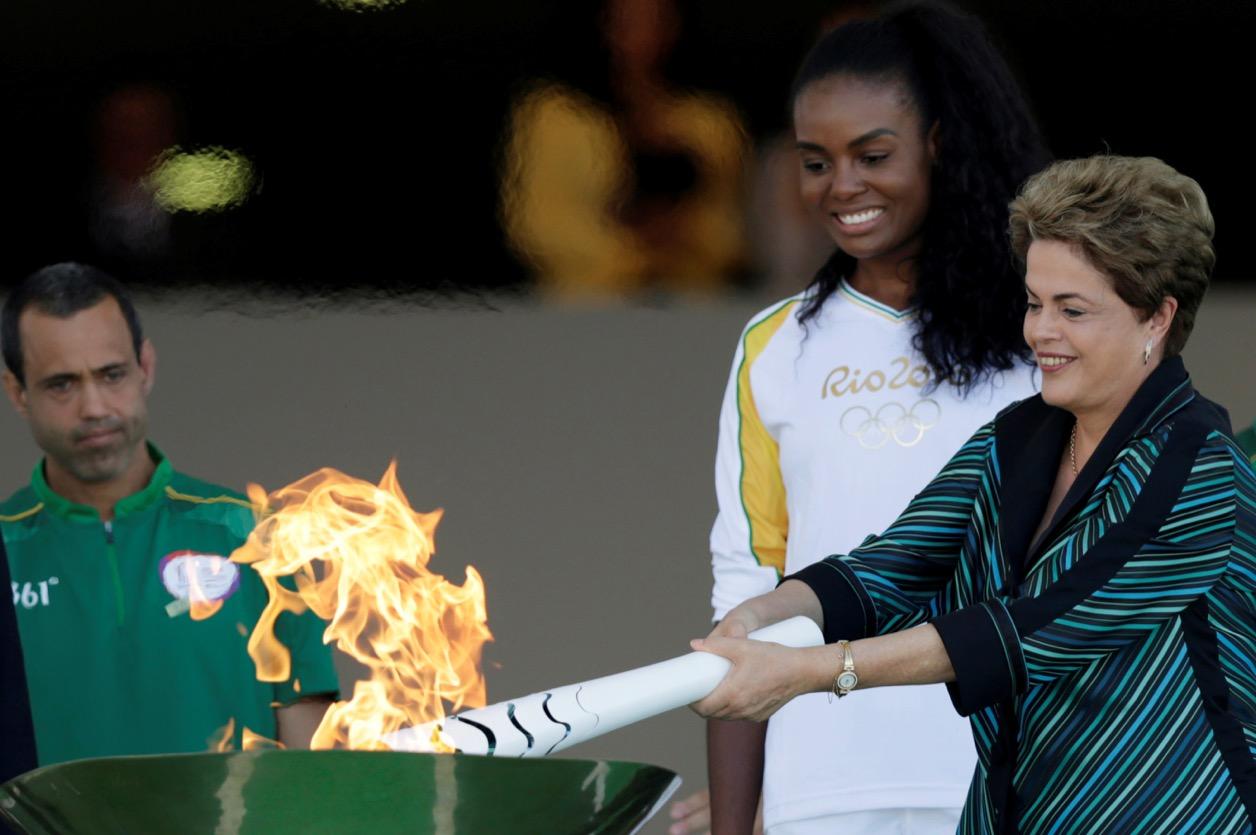 Brazil's President Dilma Rousseff lights a cauldron with the Olympic Flame