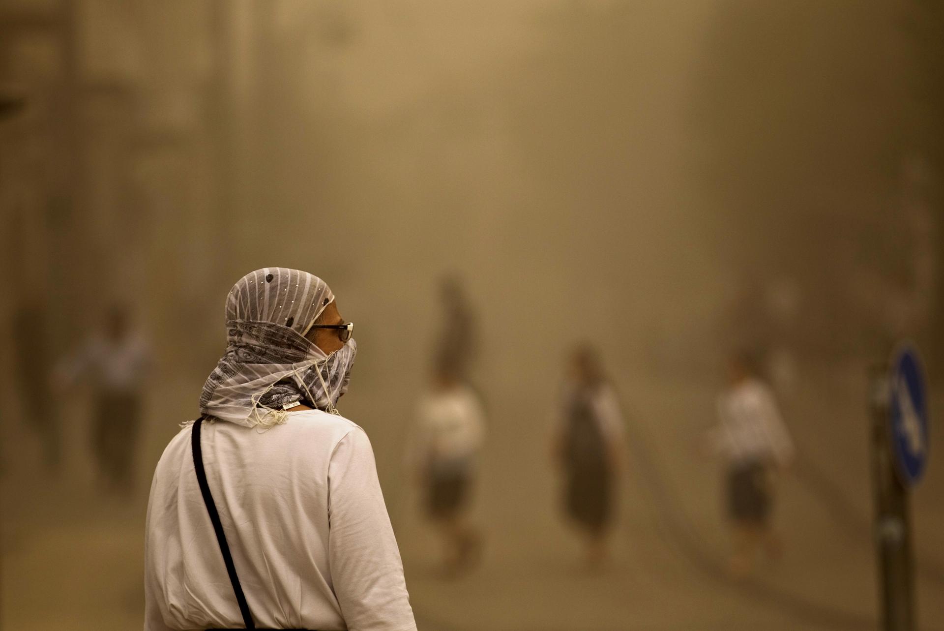 A pedestrian walks with a covered face during a sandstorm in Jerusalem September 8. Clouds of dust have engulfed Israel, Jordan and Cyprus.