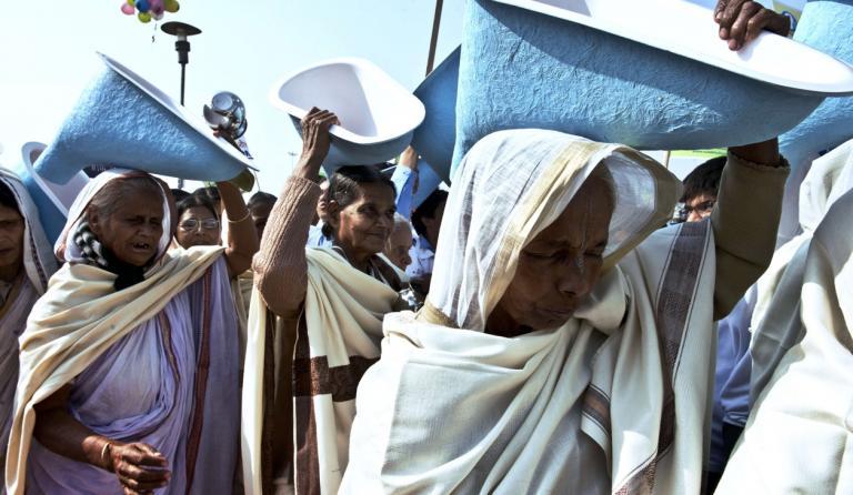 Indian women hold toilets as they participate in the opening ceremony of the three-day International Toilet Festival in New Delhi on Nov. 18, 2014, the eve of World Toilet Day.