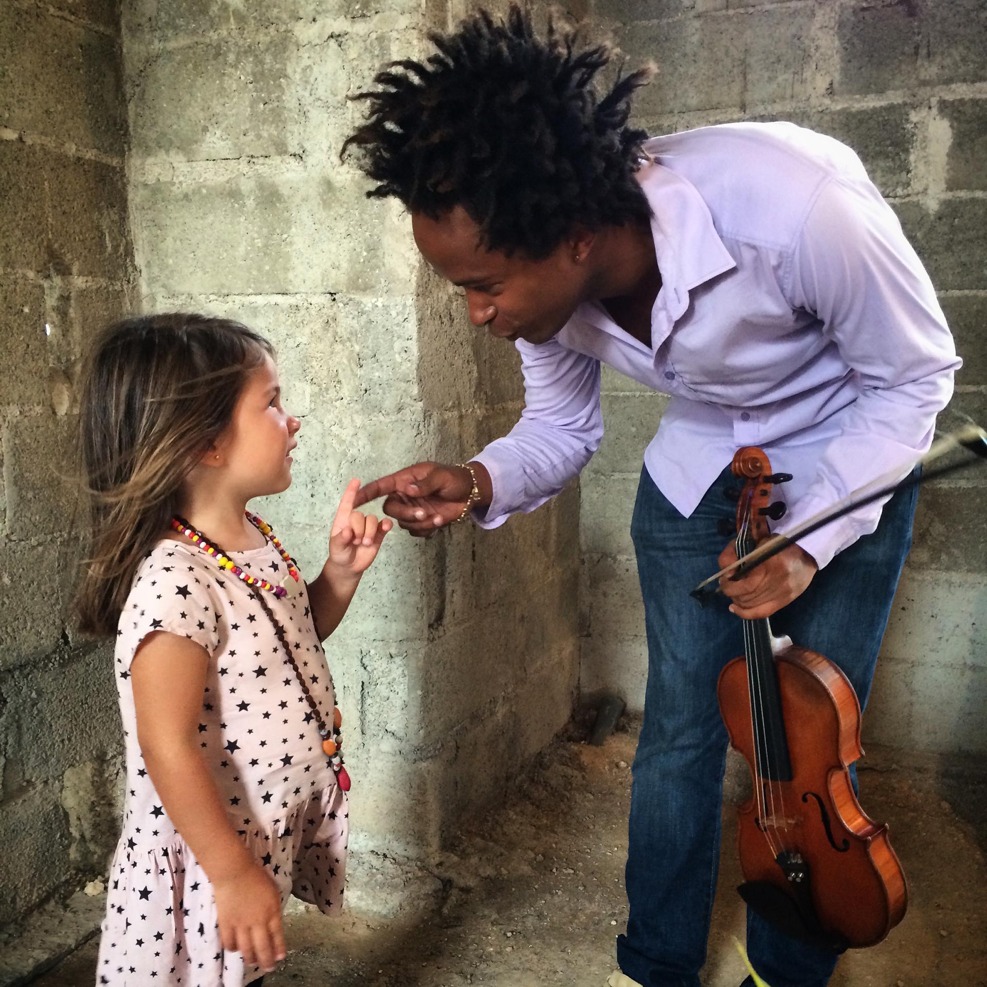 Violinist Alejandro Junco chats with a young classical music fan at an art exhibition in Havana. He's a graduate of Cuba's prestigious arts school, Instituto Superior de Arte (ISA). I met Alejandro as he played solo violin inside the ruins of an old build