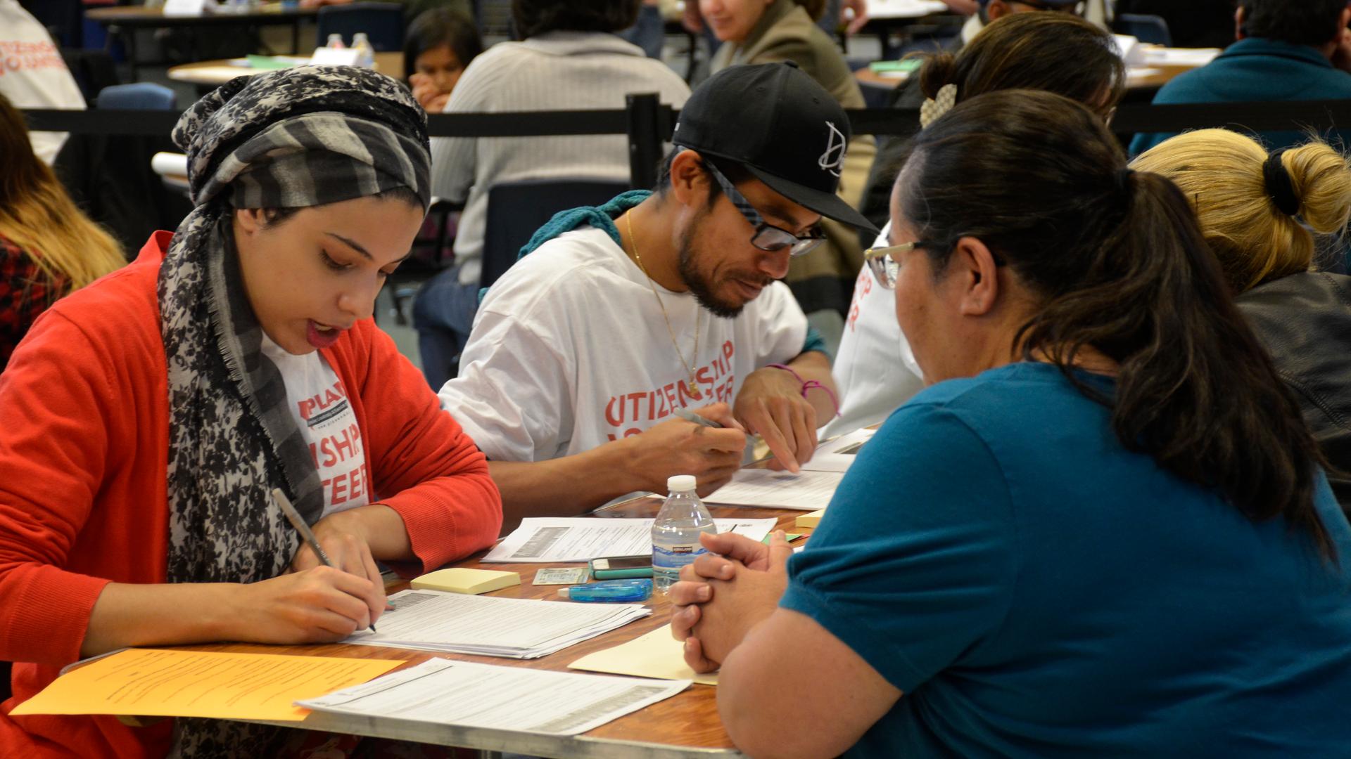 Volunteers at a Las Vegas high school help immigrants fill out the application for US citizenship.