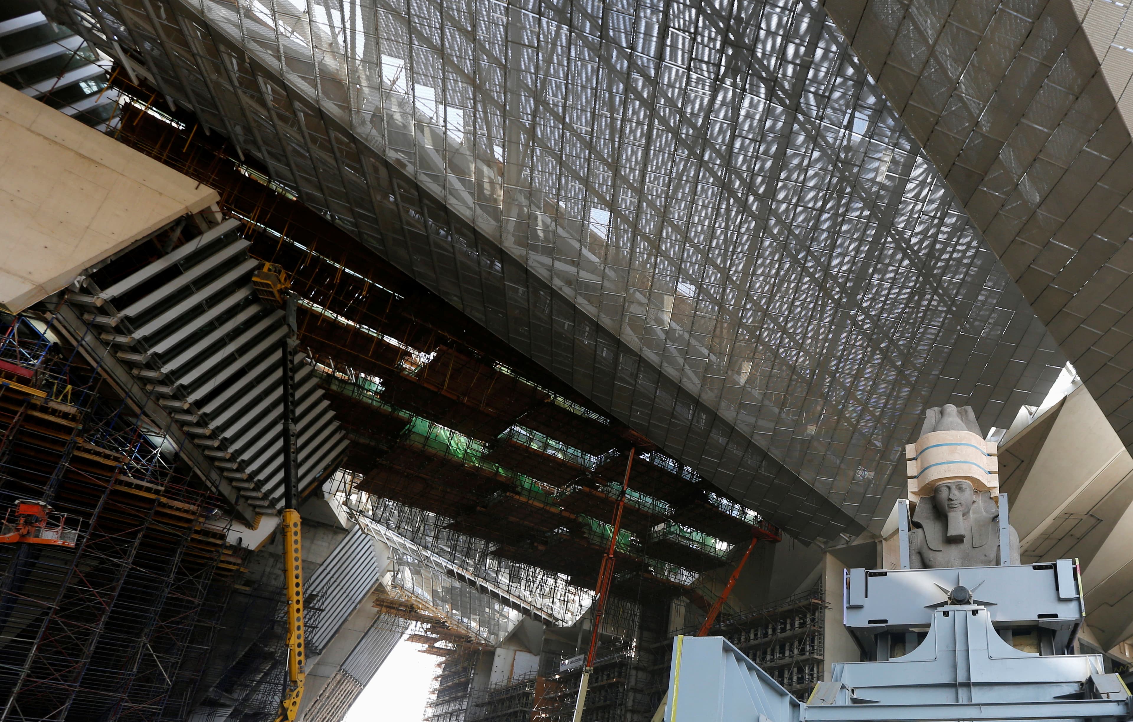 The Statue of King Ramses II is seen next to construction workers