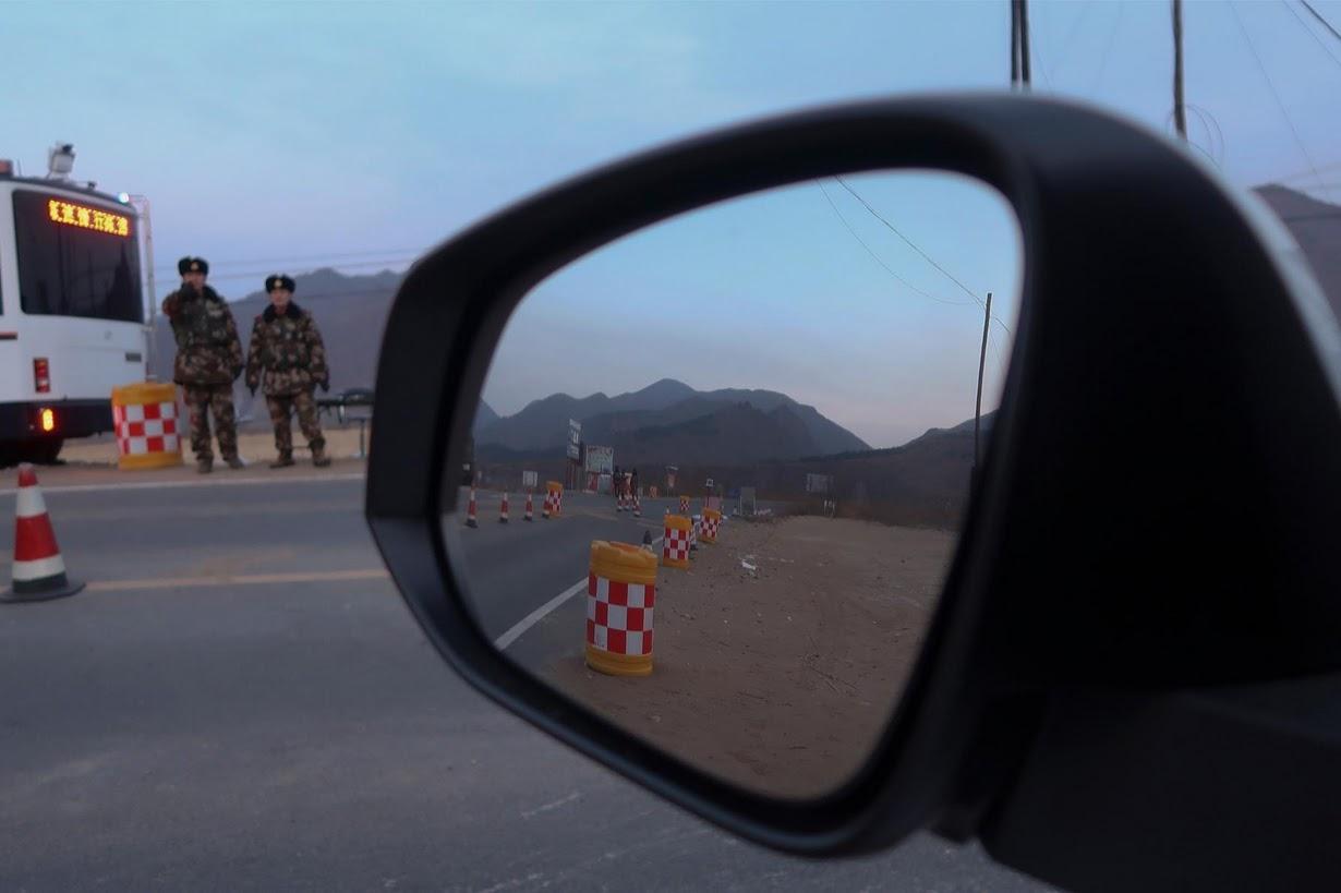 Policemen control a check point after preventing Reuters reporters from driving through, near the border of China and North Korea,