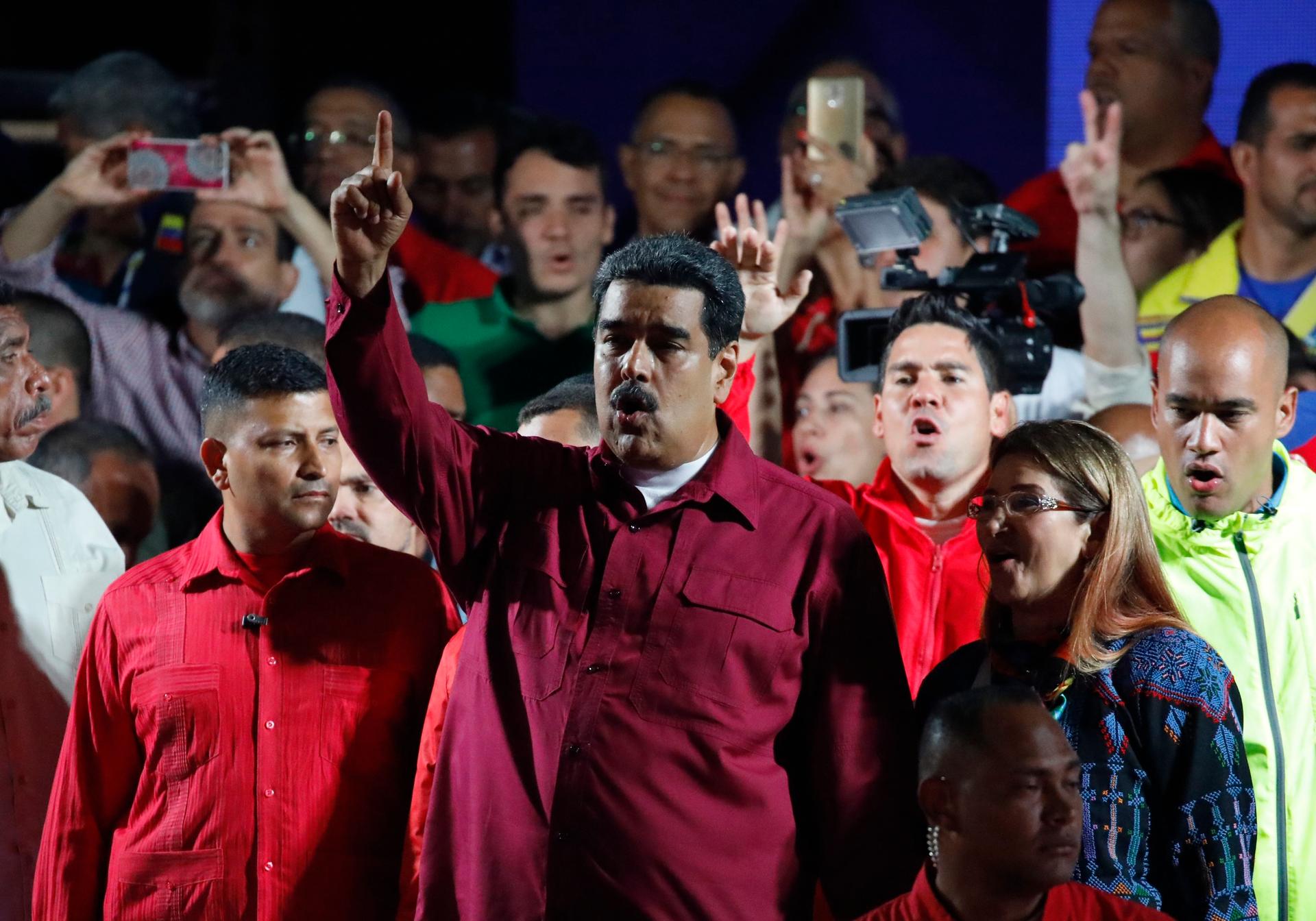 Venezuela's President Nicolas Maduro raises a finger