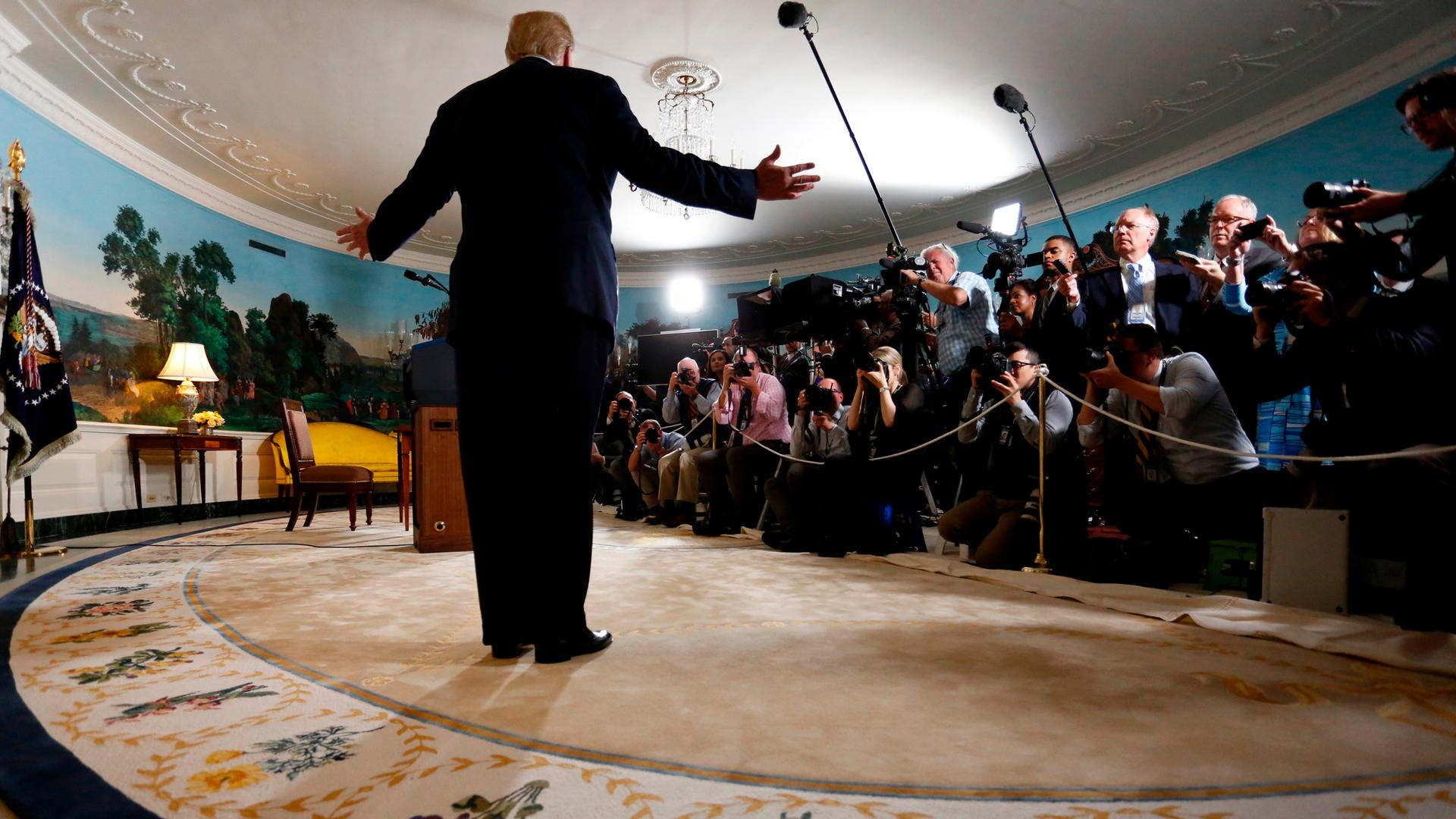 President Donald Trump reacts to a question from a reporter after the president announced his intention to withdraw from the Iran nuclear agreement.