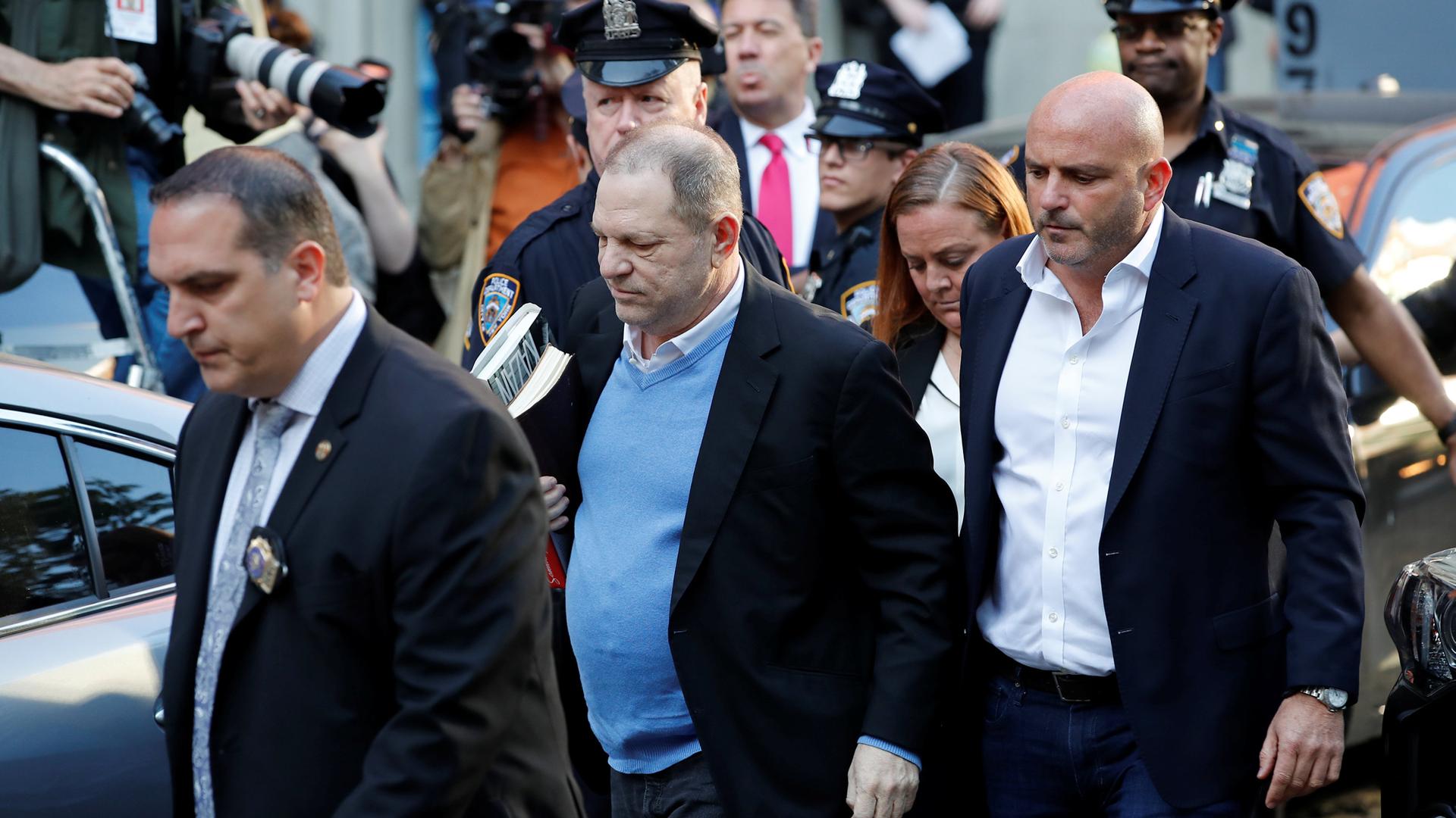 Film producer Harvey Weinstein, surrounded by NYC authorities, arrives at the 1st Precinct in Manhattan.