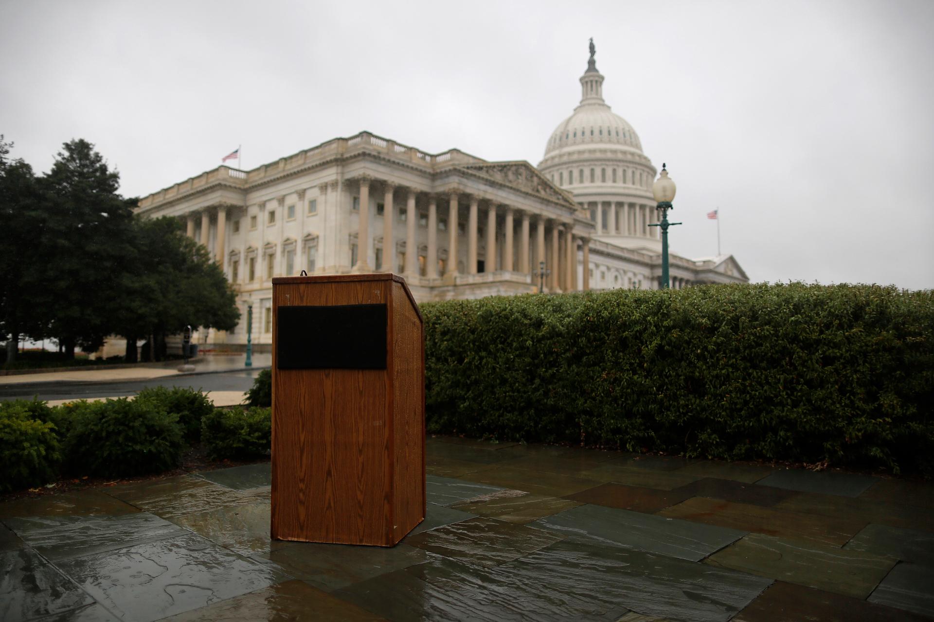 An empty speaker's lectern is seen in the rain outside the US Capitol in Washington, October 10, 2013.