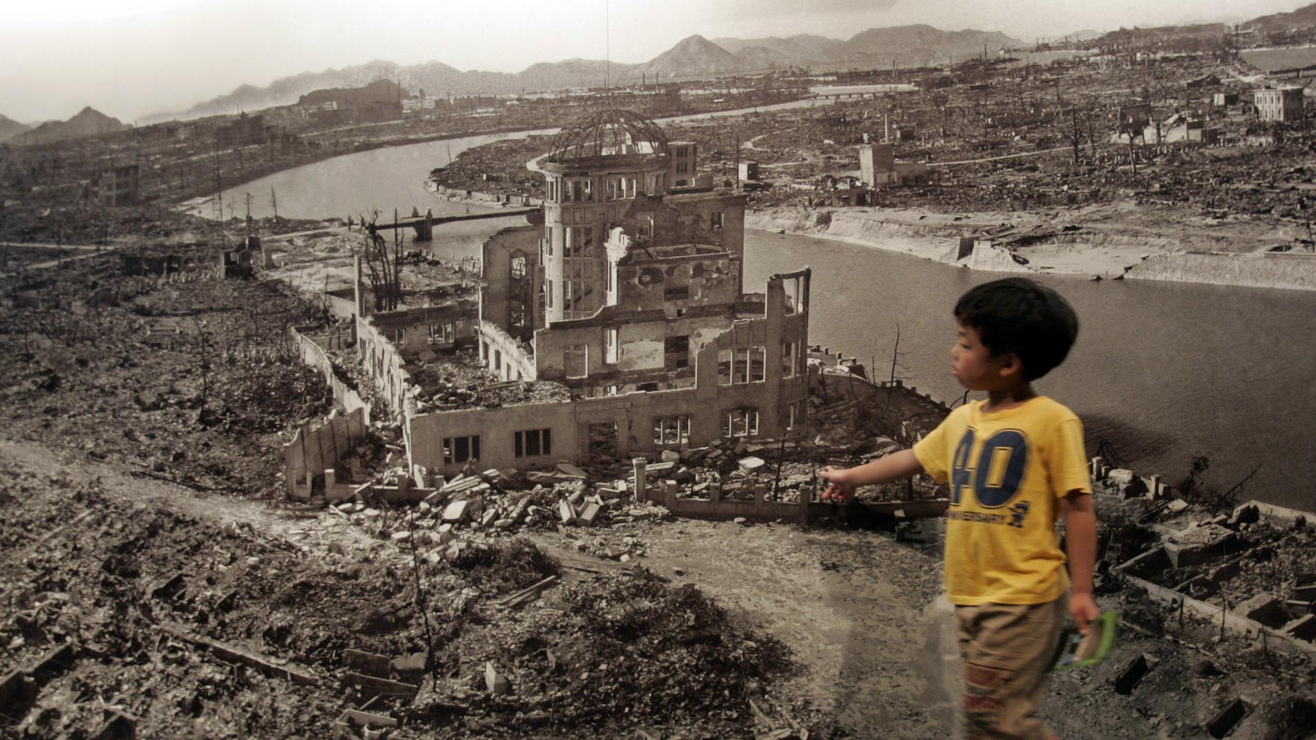 A boy looks at a photograph showing Hiroshima city after the 1945 atomic bombing, at the Hiroshima Peace Memorial Museum, Japan, Aug. 6, 2007.