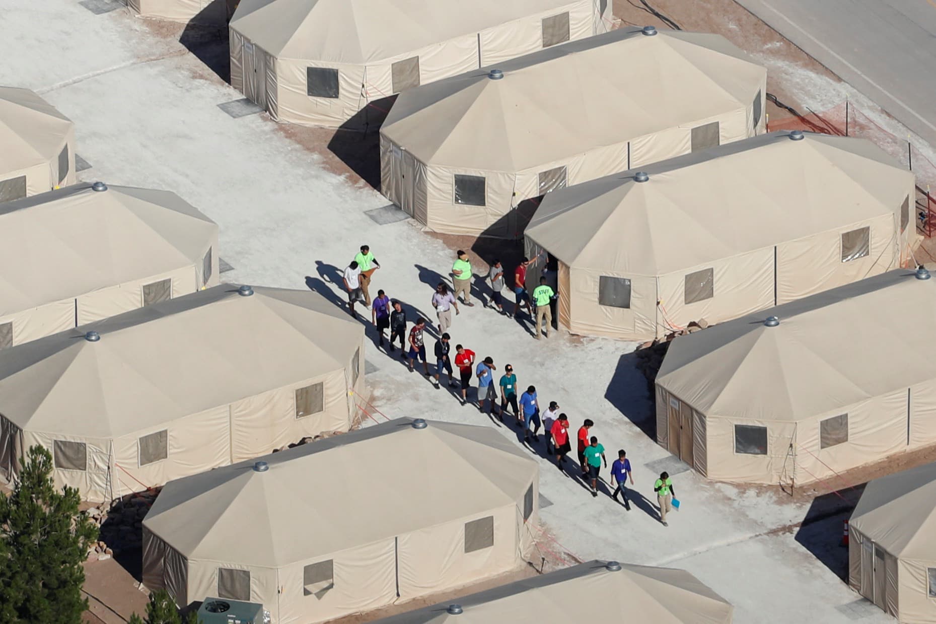 Aerial view of tents with line of people in the middle