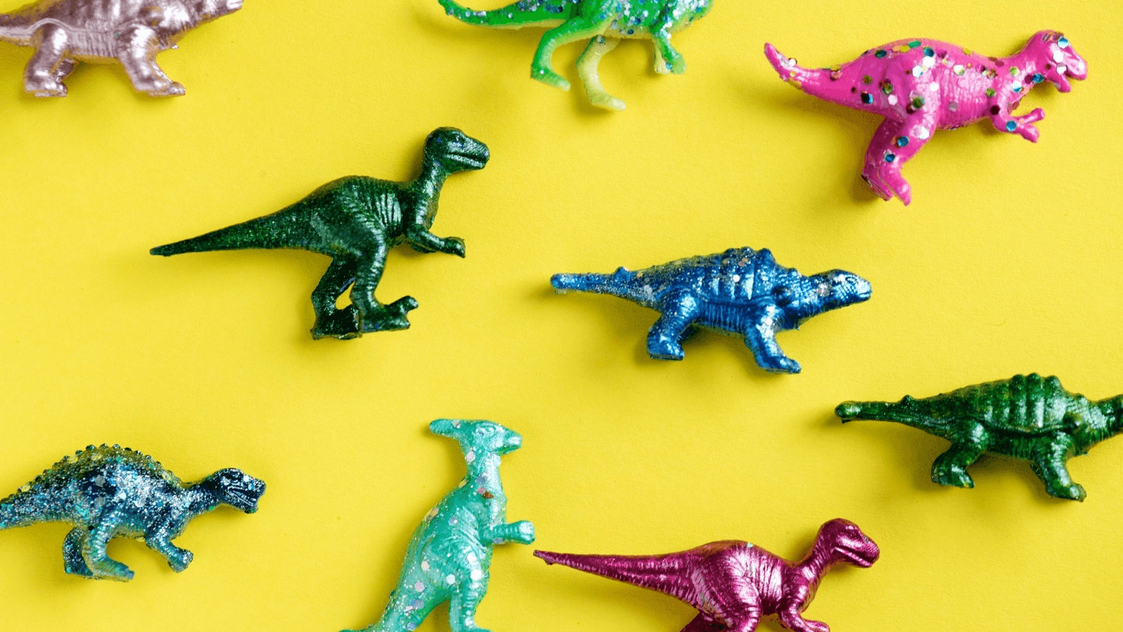toy dinosaurs on a yellow background