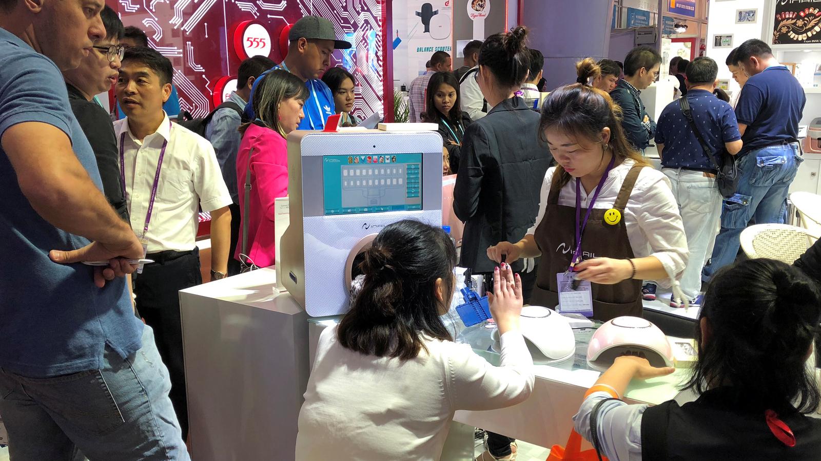 People visit a nail polish booth at the China Import and Export Fair in Guandgong province, China.