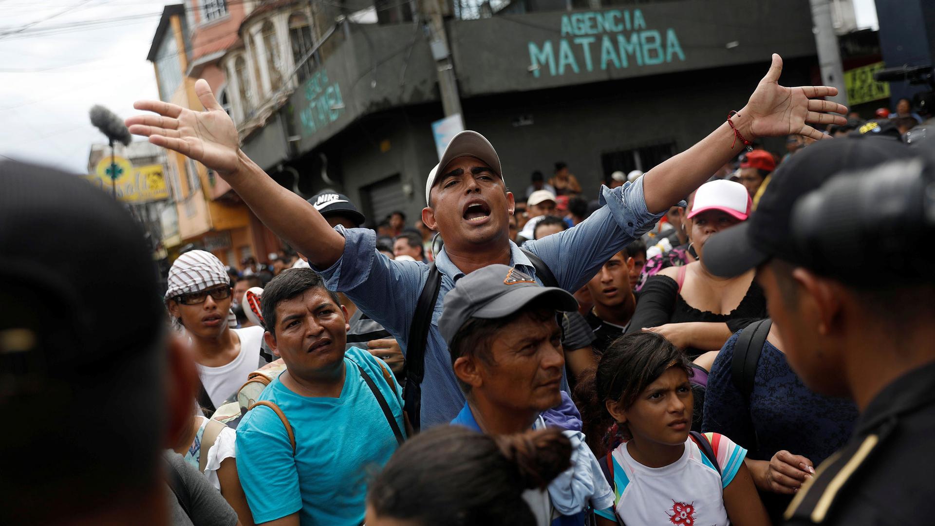 A group of migrants, some carrying children will the streets in this photo near the border with Mexico, in Tecun Uman, Guatemala, Oct. 19, 2018.