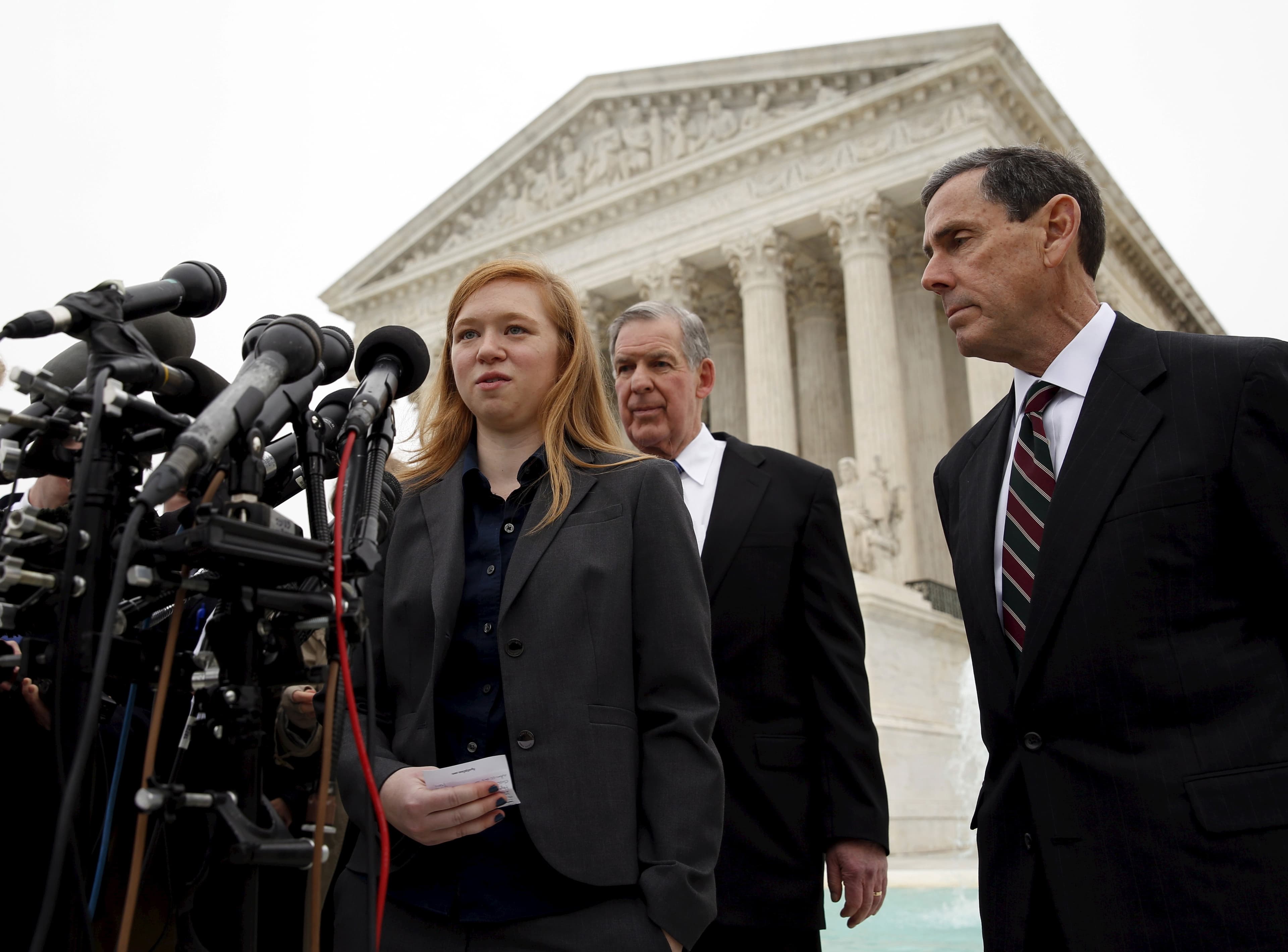Woman at podium in front of Supreme Court