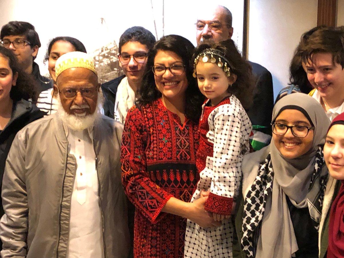 Congresswoman Rashida Tlaib (D-MI), the first Palestinian-American elected to the House, poses in her Palestinian thobe, surrounded by friends and family