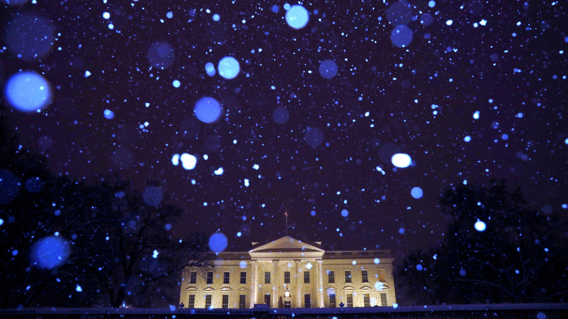 Snow from Winter Storm Gia falls over the White House