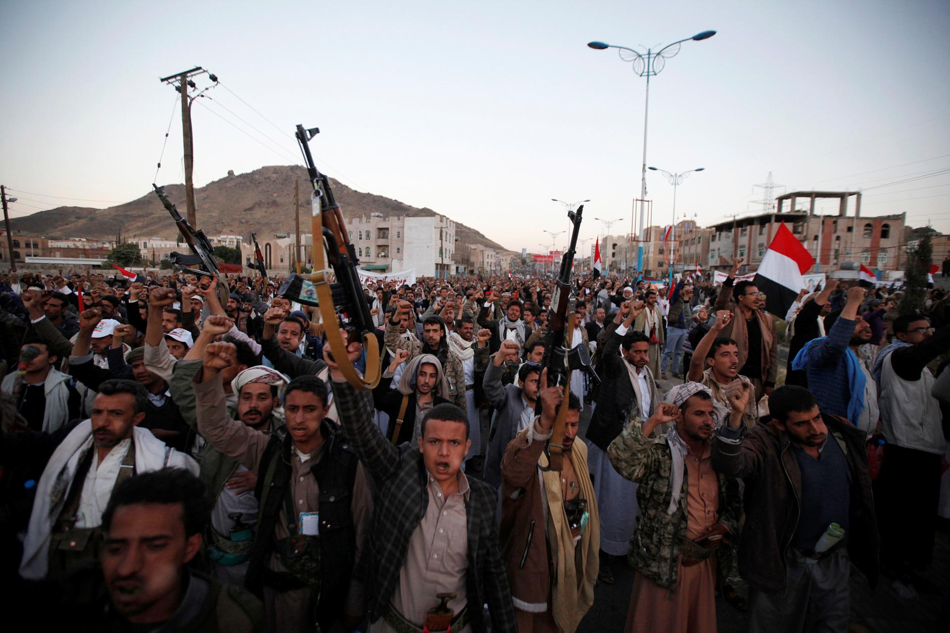 Followers of the Shi'ite Houthi movement shout slogans as they attend a rally