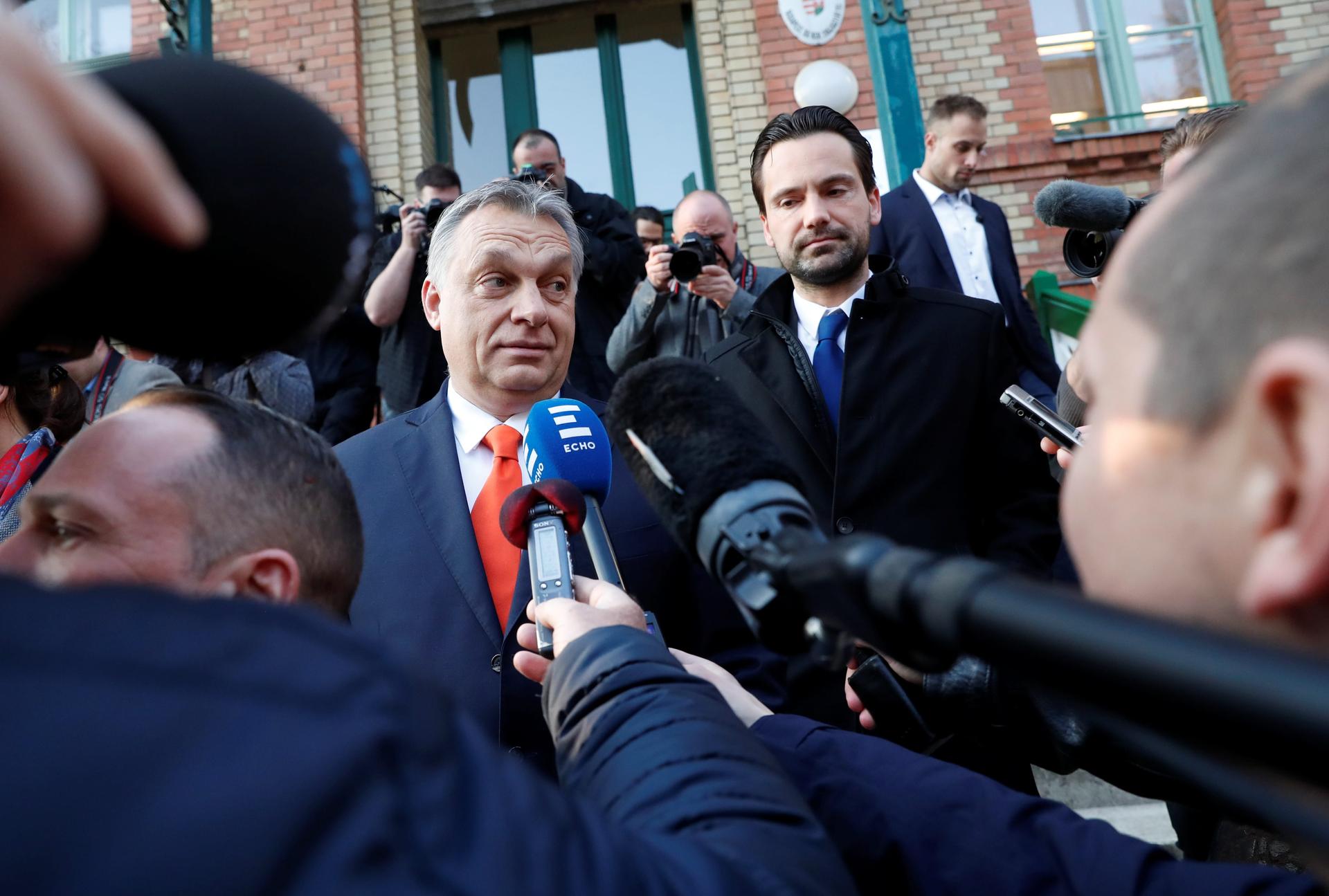 Current Hungarian Prime Minister Viktor Orban surrounded by microphones